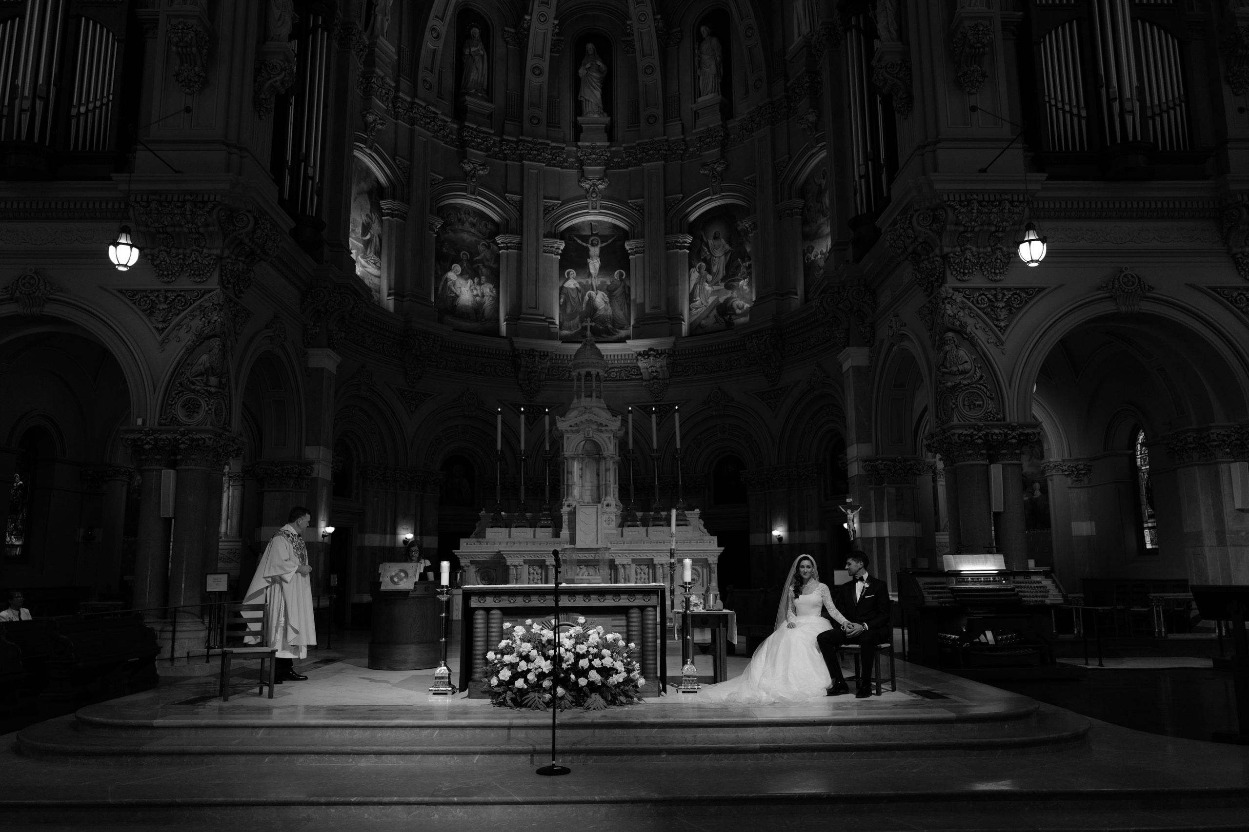 a bride and groom are standing in front of the altar