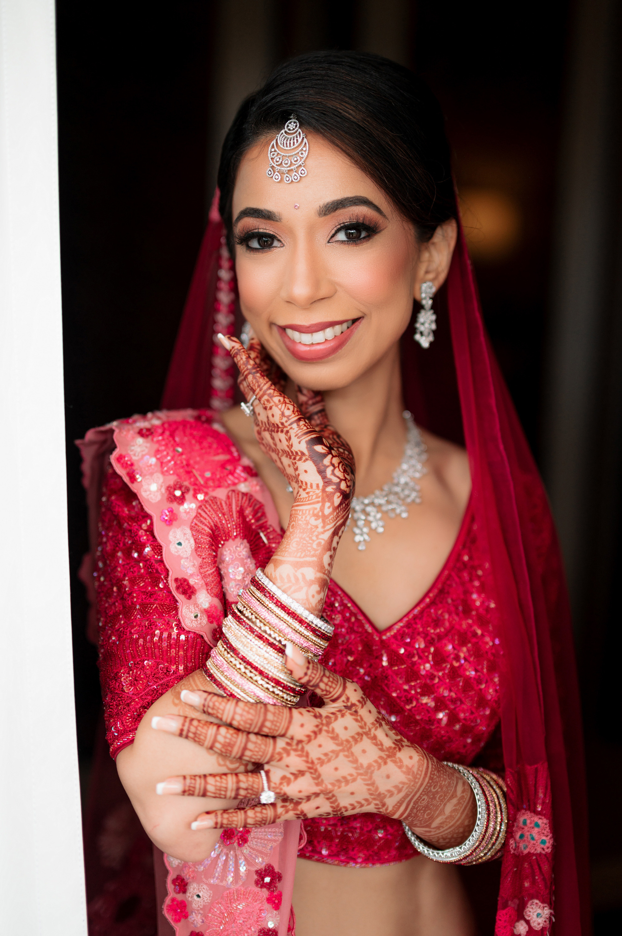 a bride in a red outfit and jewellery