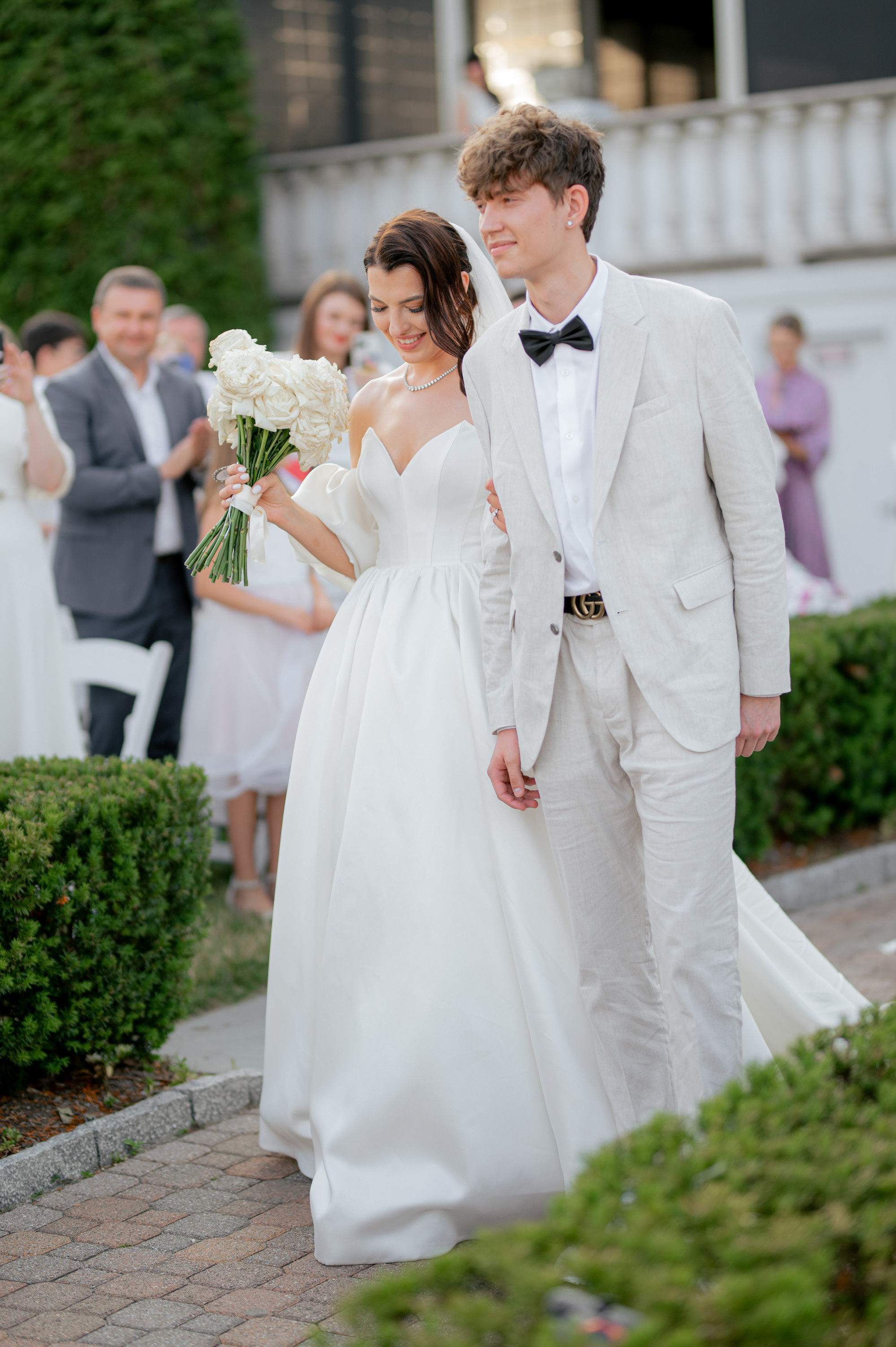 a bride and groom walking down the aisle
