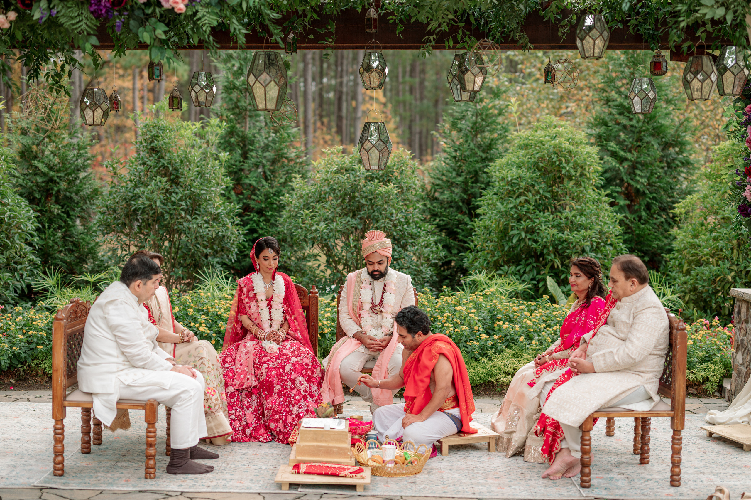 a group of people sitting on chairs in a garden