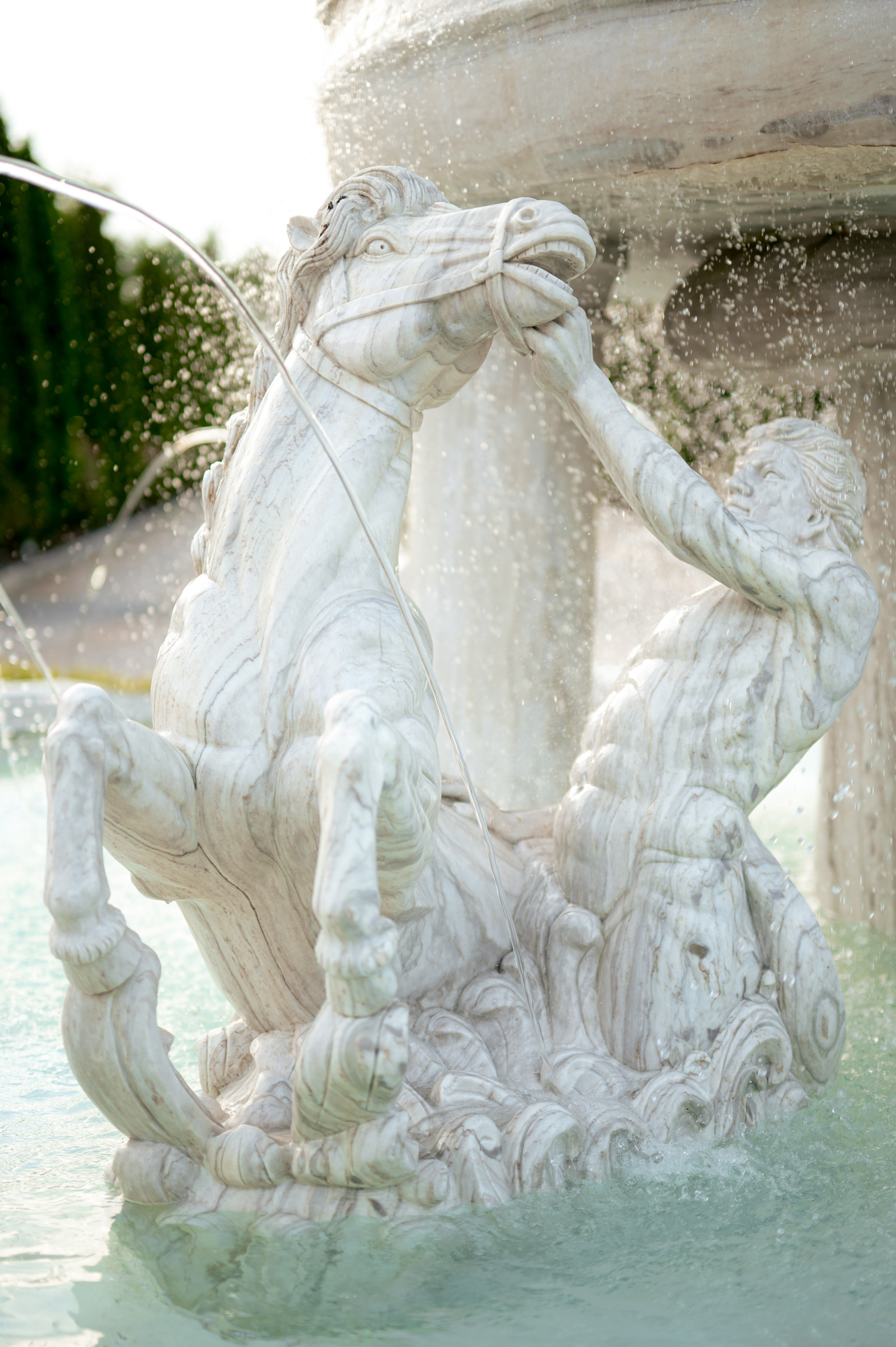 a fountain with a statue of a horse and a man