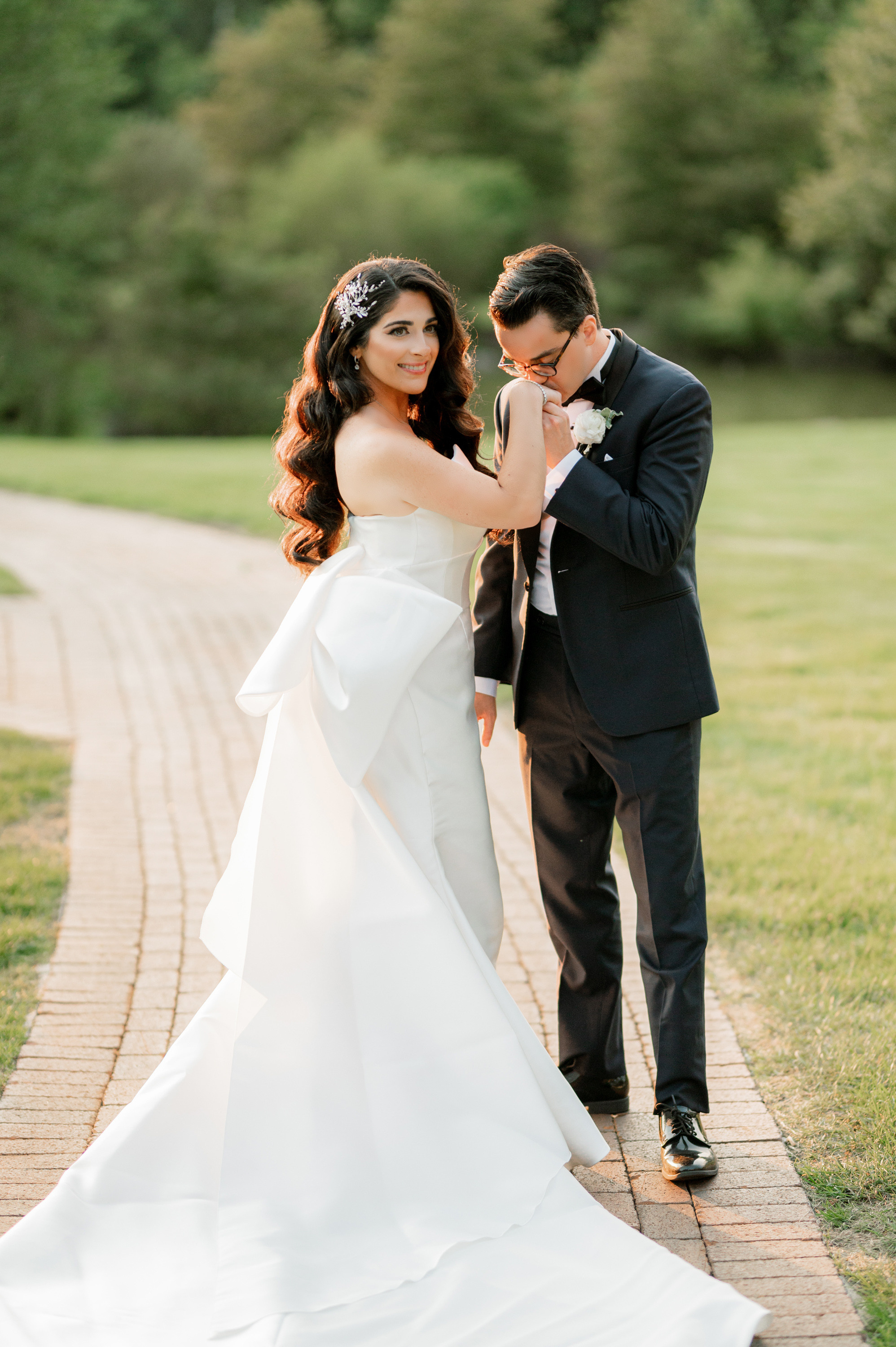 a bride and groom pose for a photo in the park