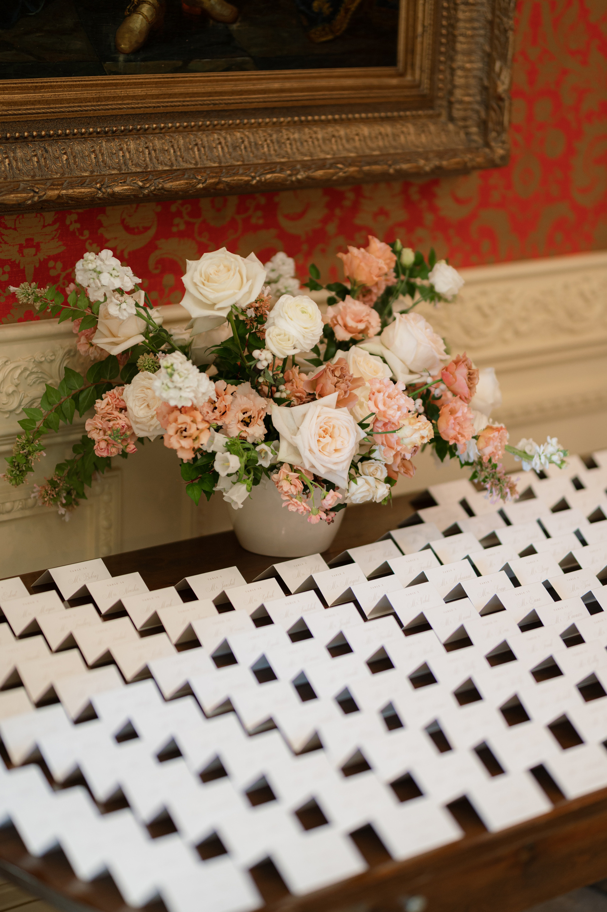 a vase of flowers and a white and pink arrangement
