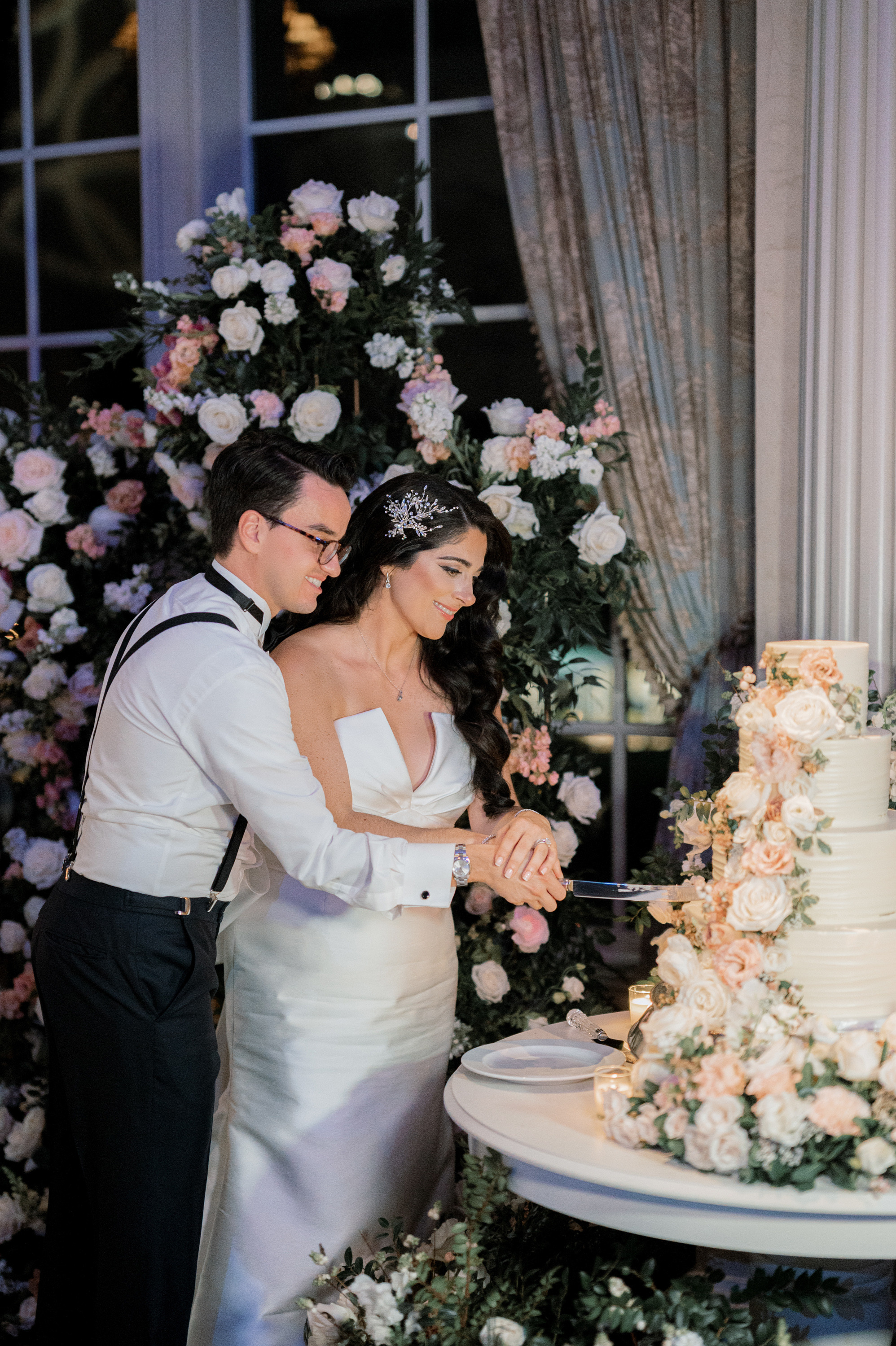 a bride and groom cutting a wedding cake