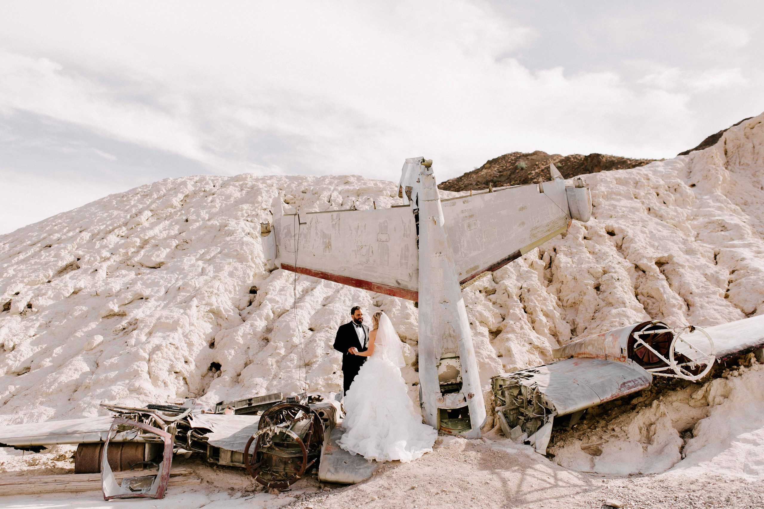 a couple standing in front of a mountain