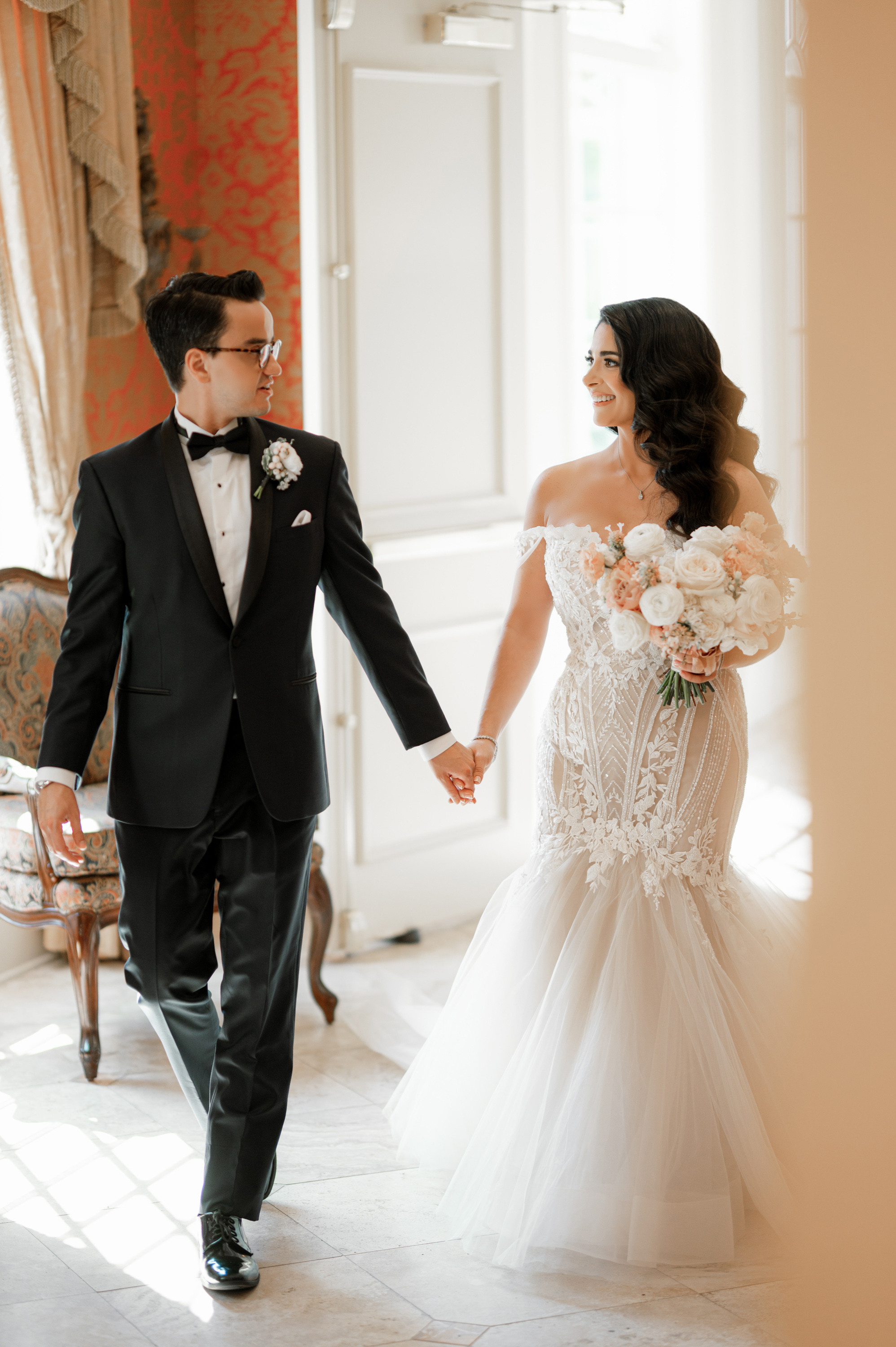 a bride and groom walking through a doorway