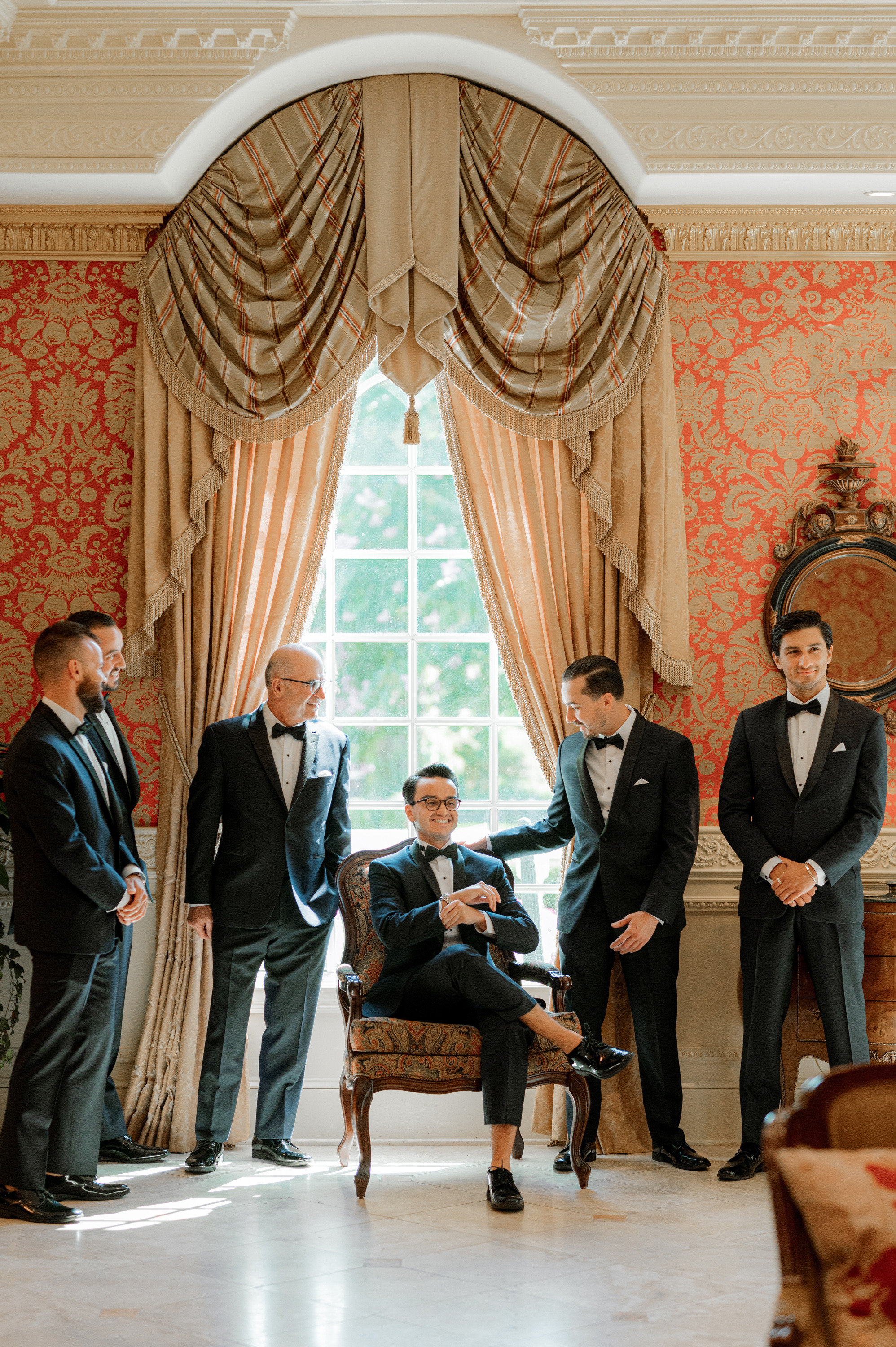a group of men in formal attire standing in a room
