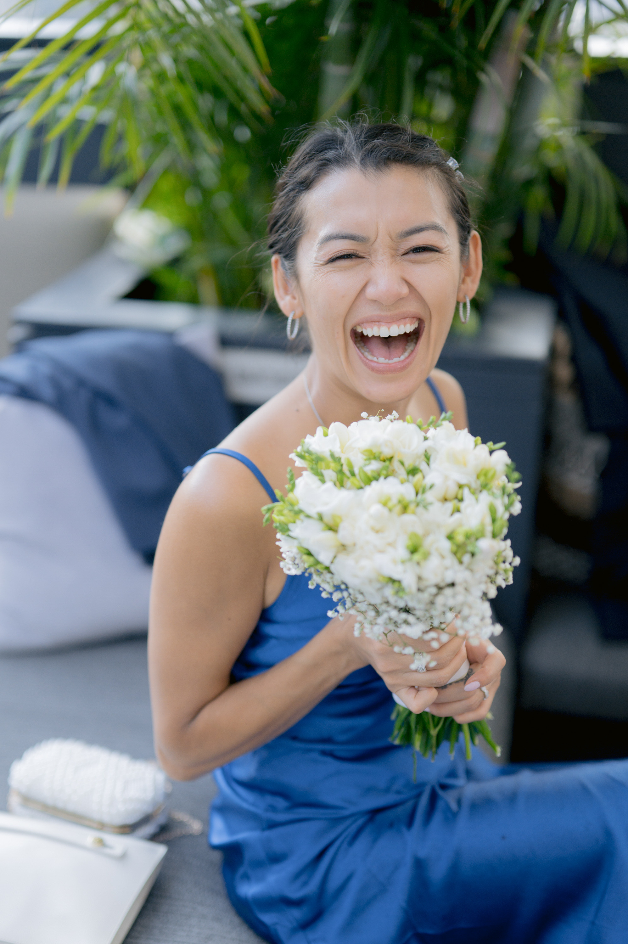a woman in a blue dress holding a bouquet of flowers