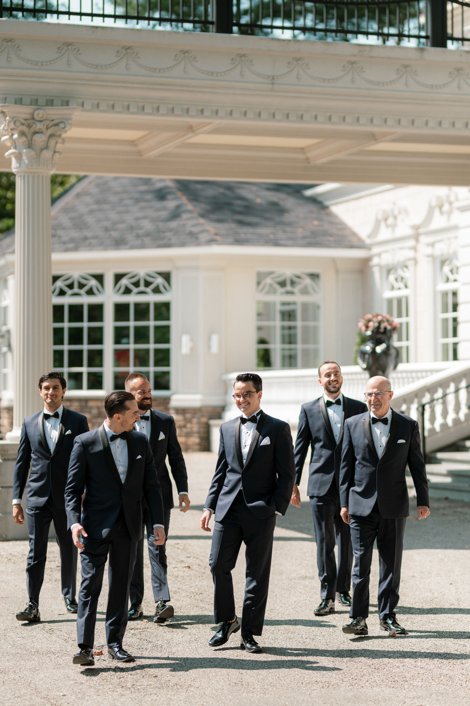 a group of men in suits walking down a street
