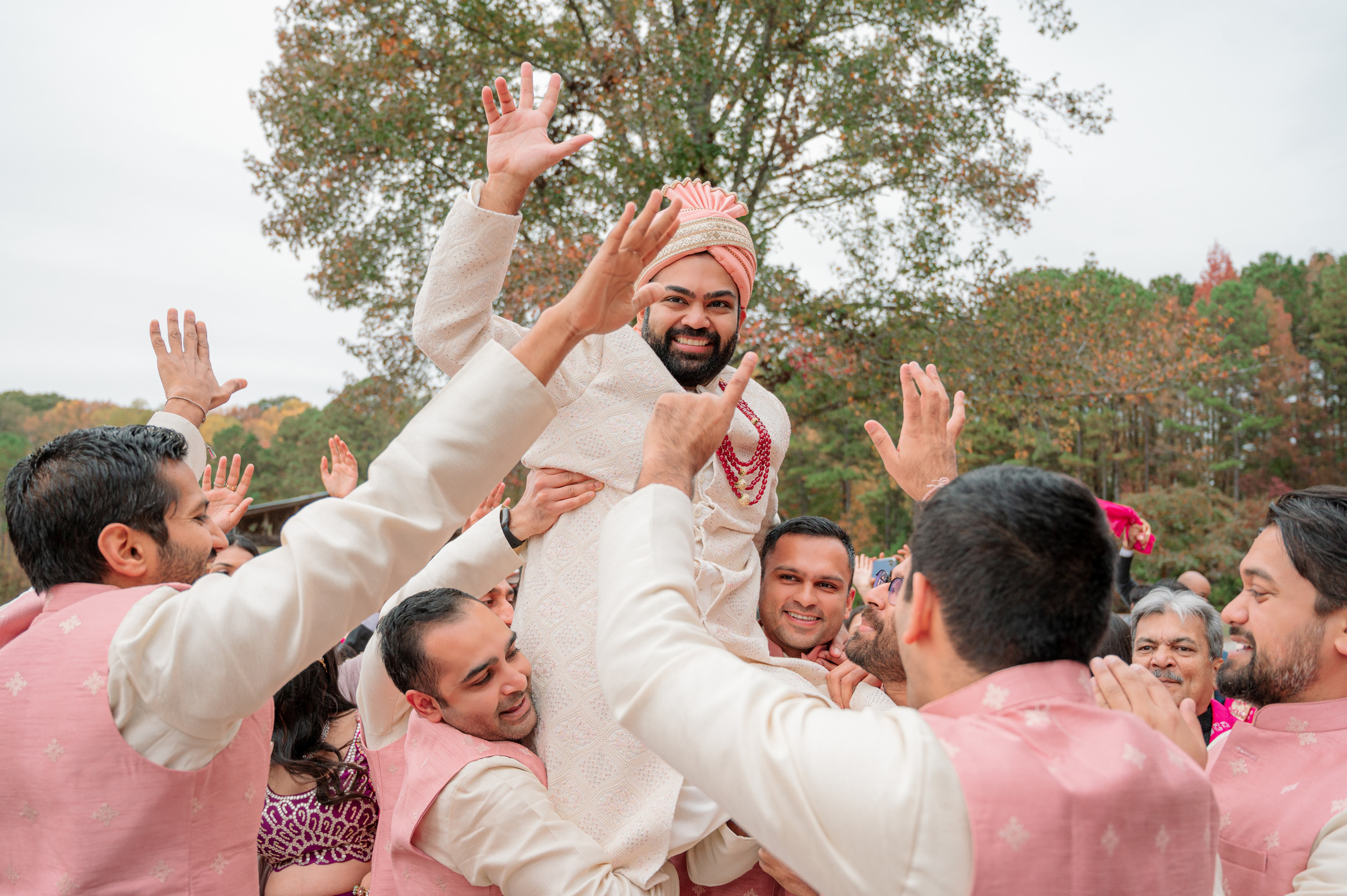 a group of people in pink and white outfits