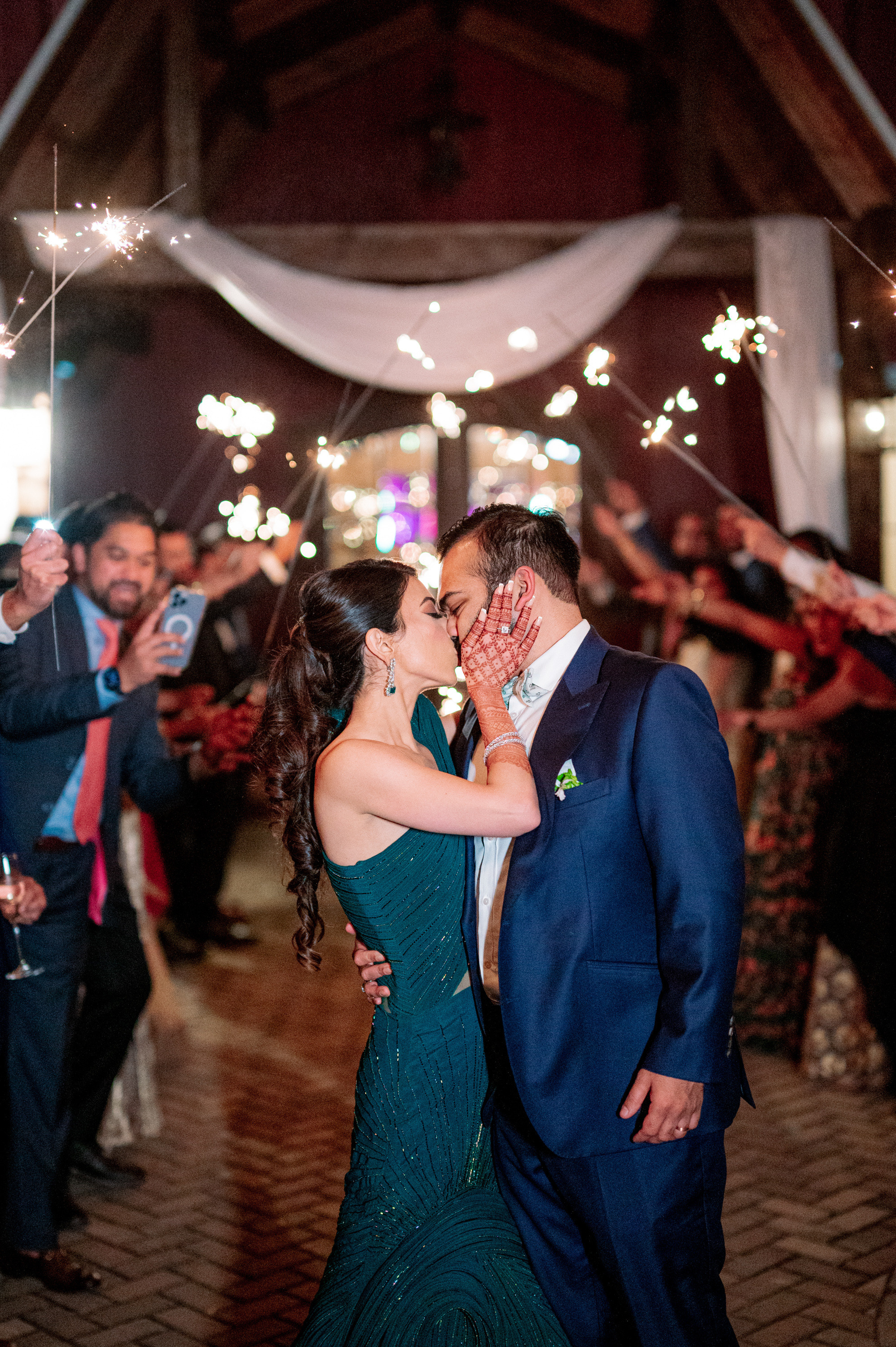 a couple kissing on a dance floor with sparkle