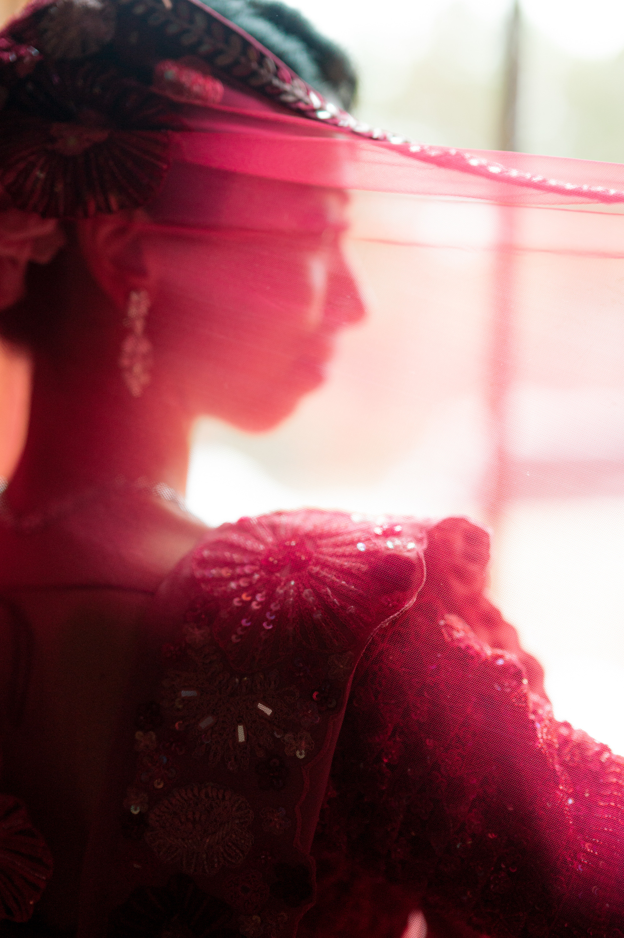 a woman in a red dress and hat