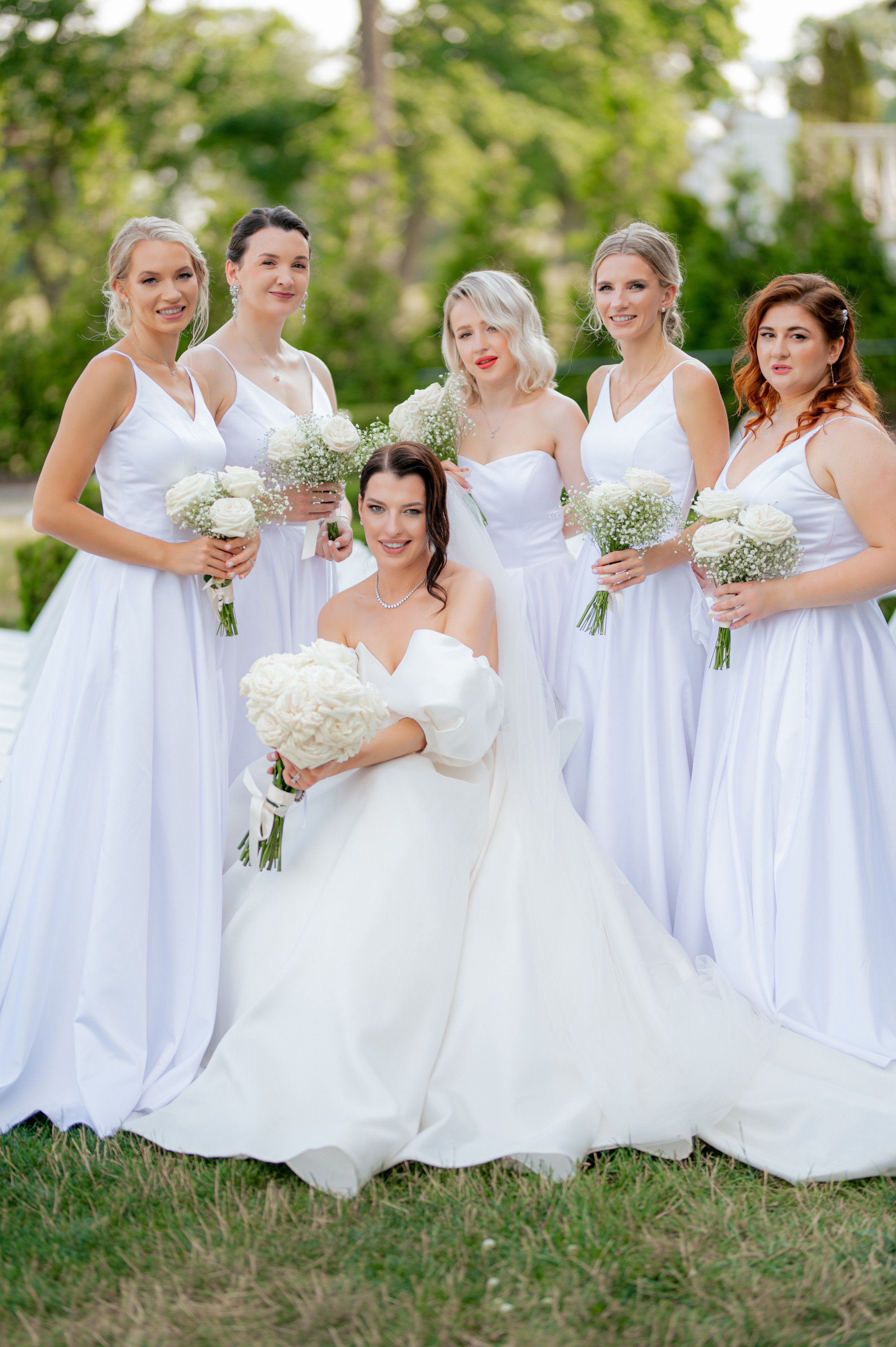 a bride and her bridesmaids pose for a photo