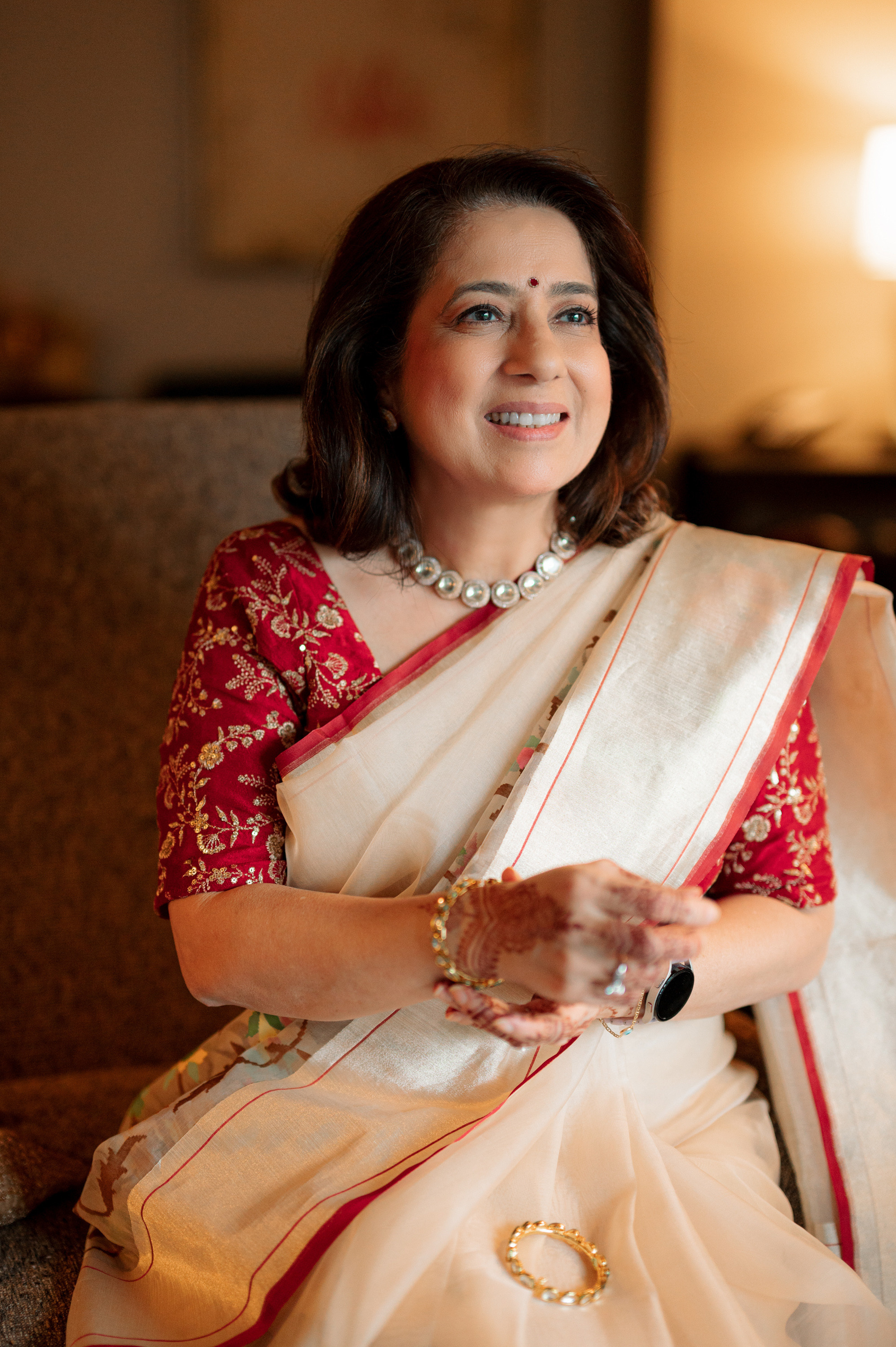 a woman in a sari sitting on a couch