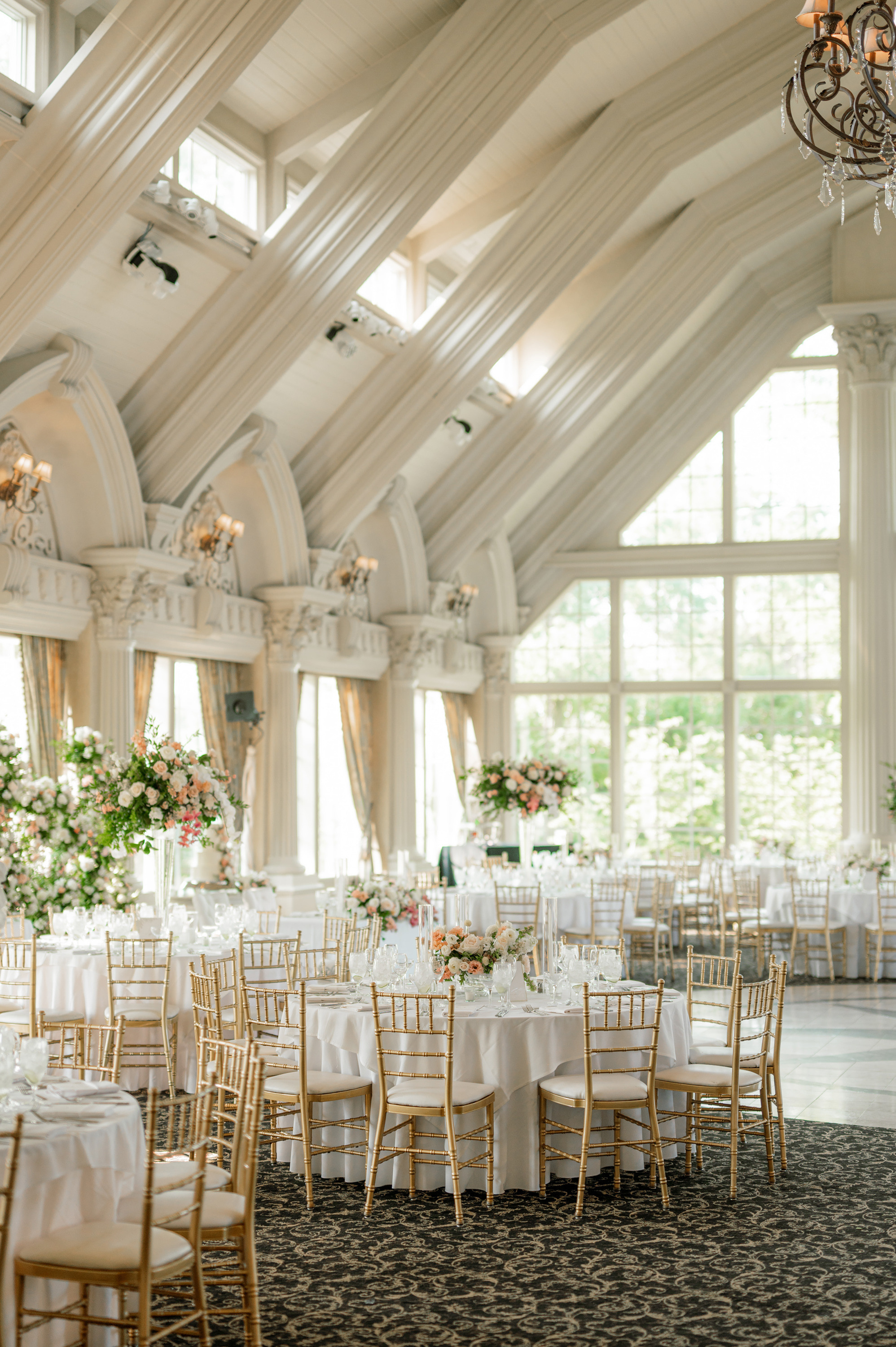 a wedding reception in a large room with white tables and chairs