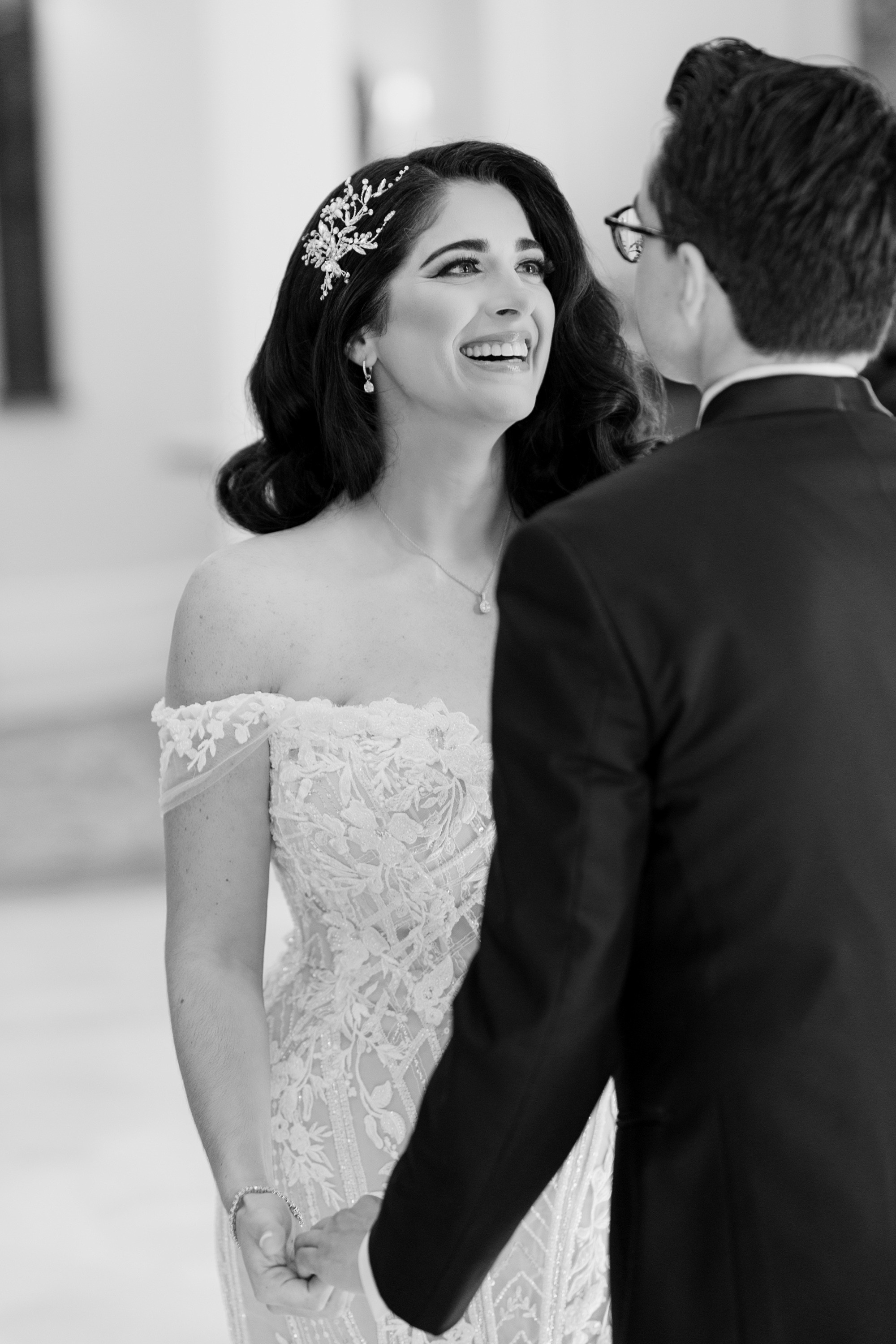a bride smiles at her groom during their wedding ceremony