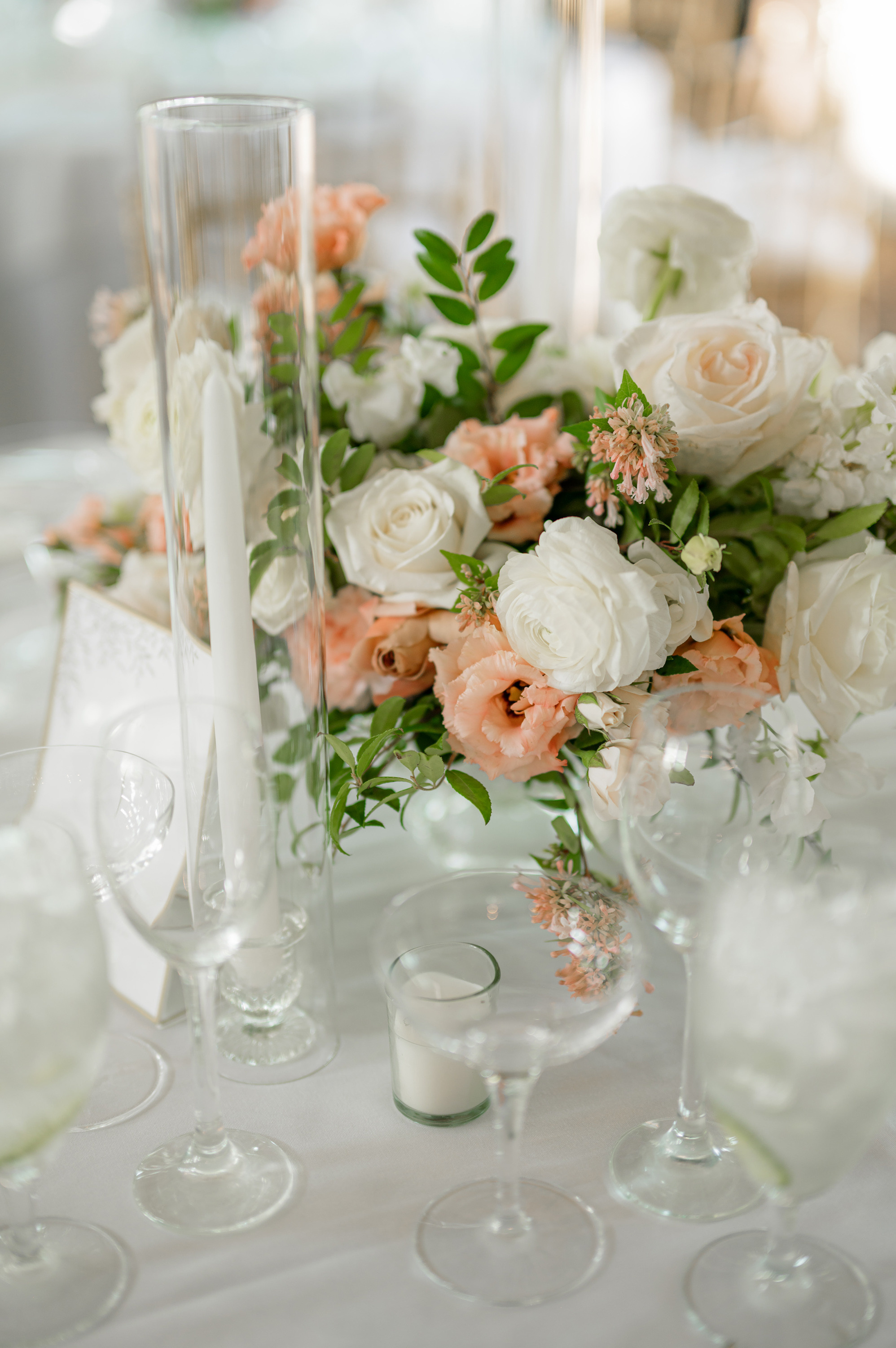 a table with a vase of flowers and candles