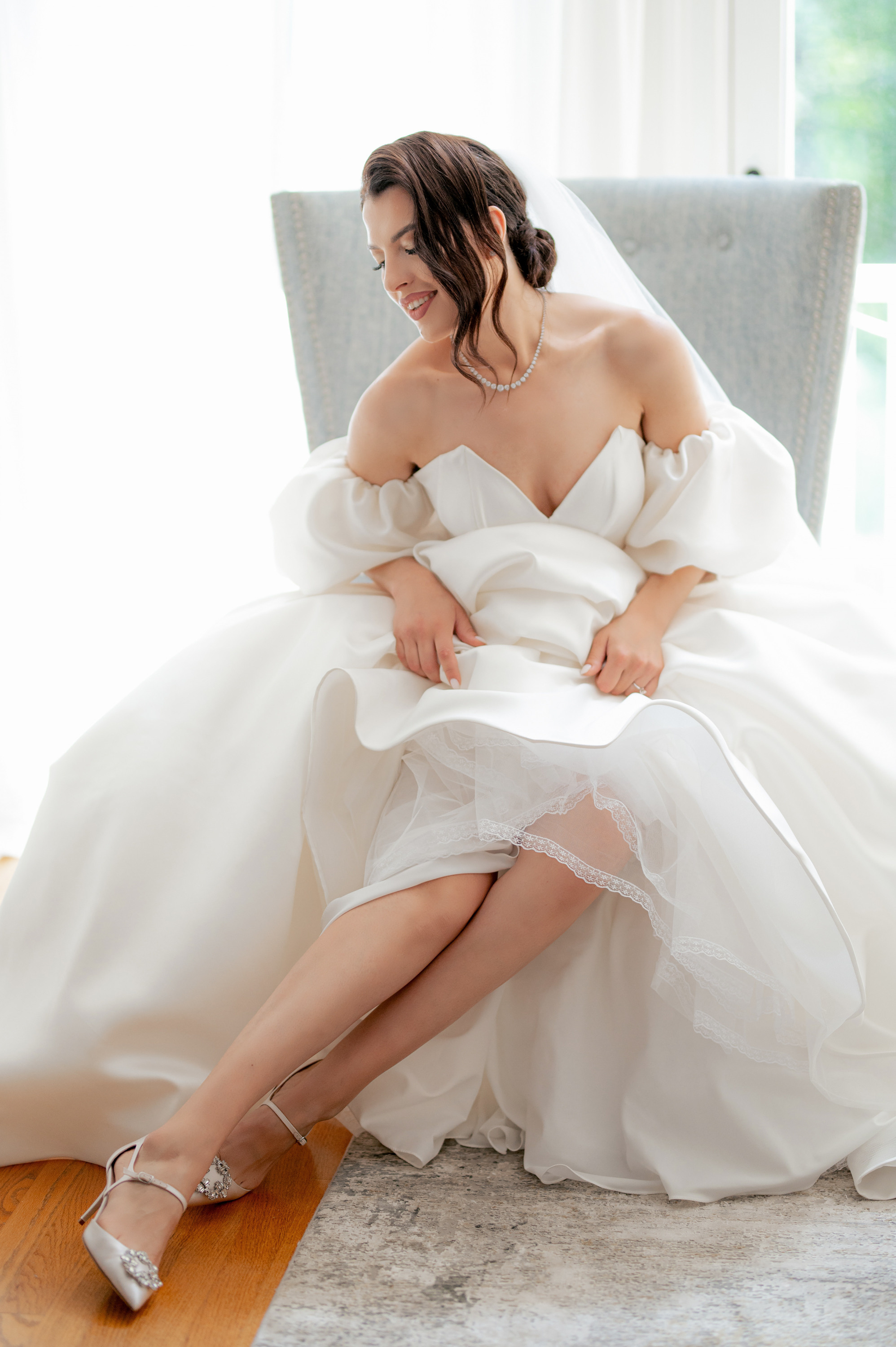 a woman in a wedding dress sitting on a chair