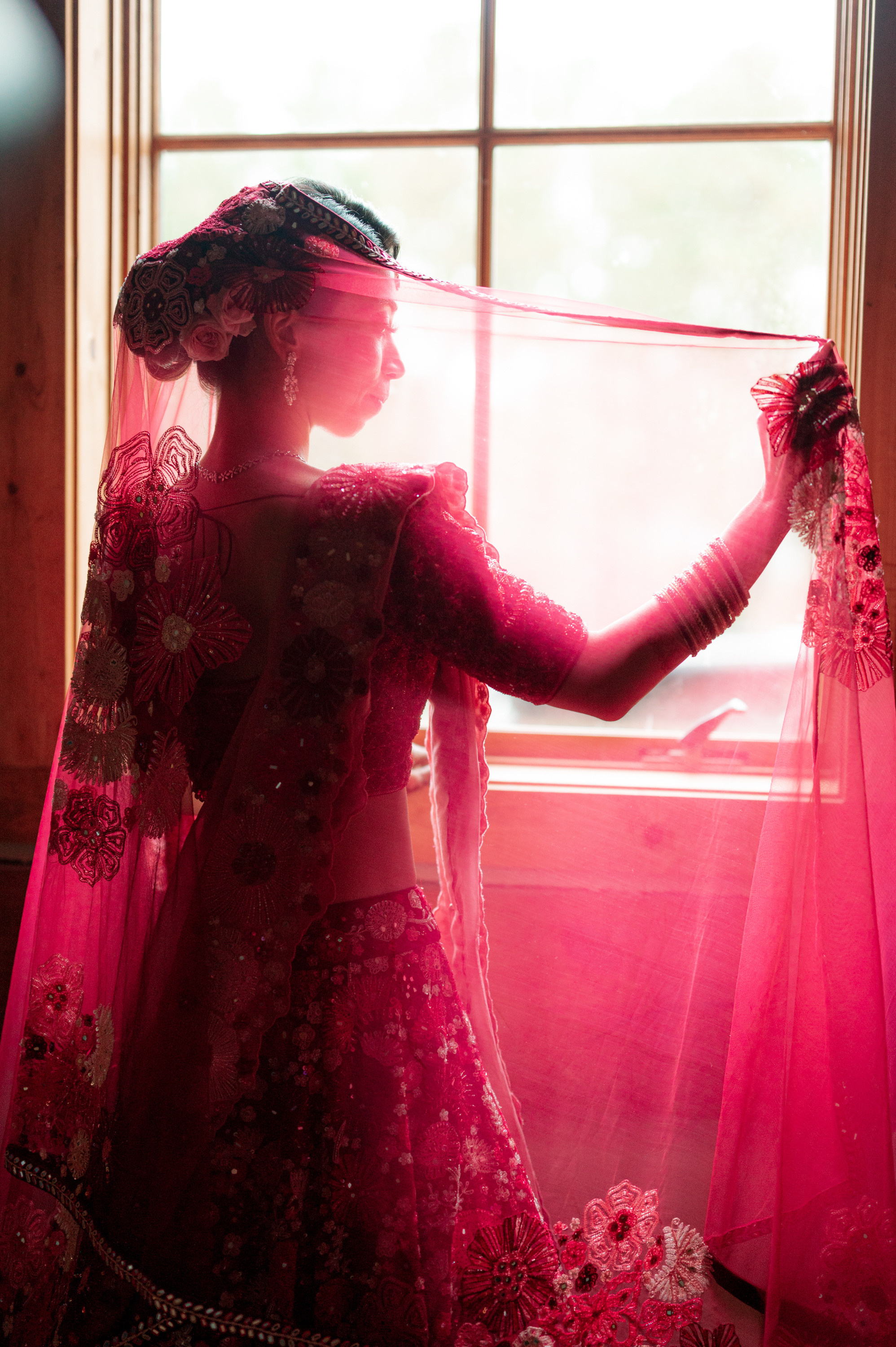 a woman in a pink dress and veil