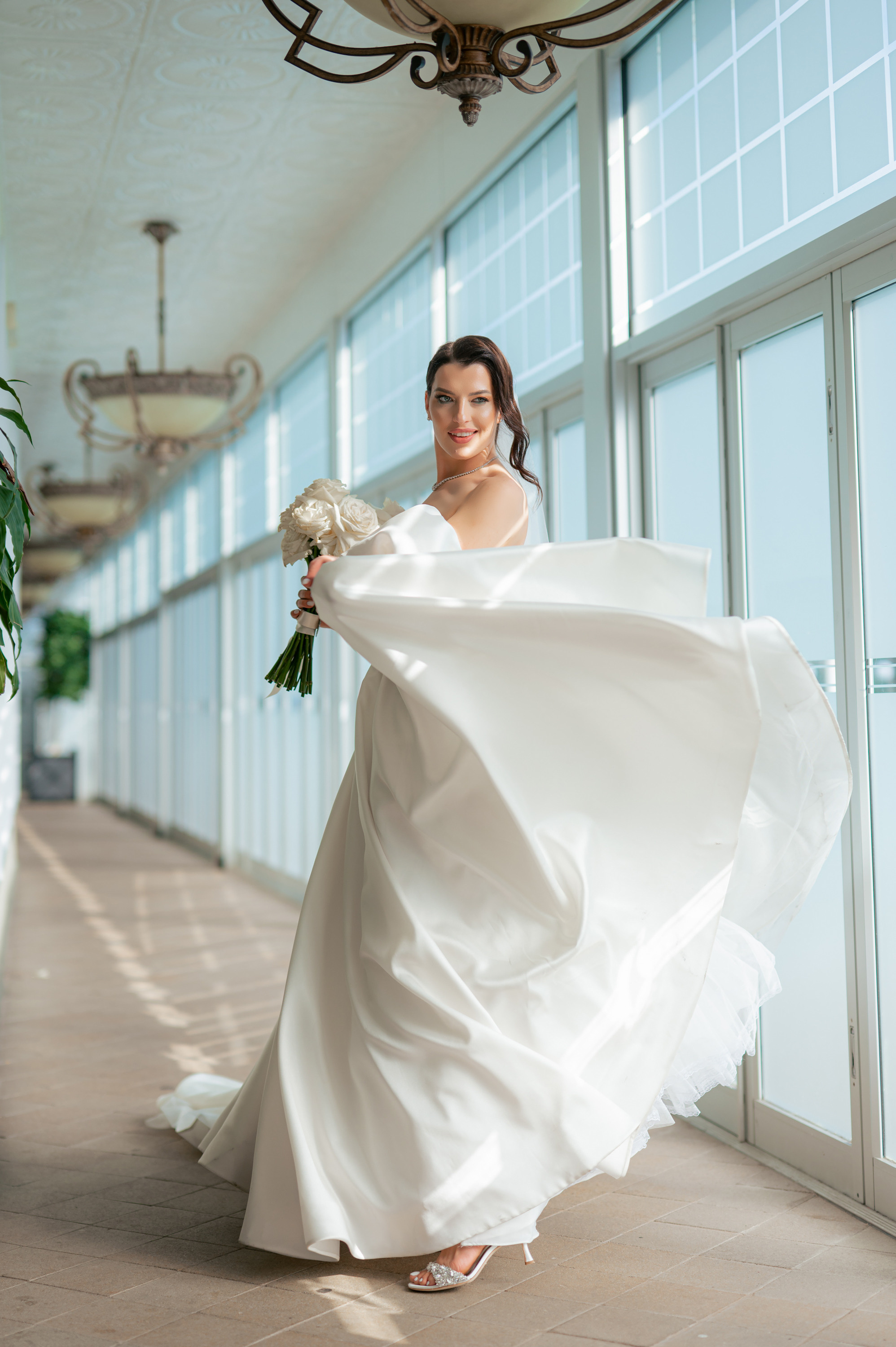 a woman in a white dress holding a bouquet