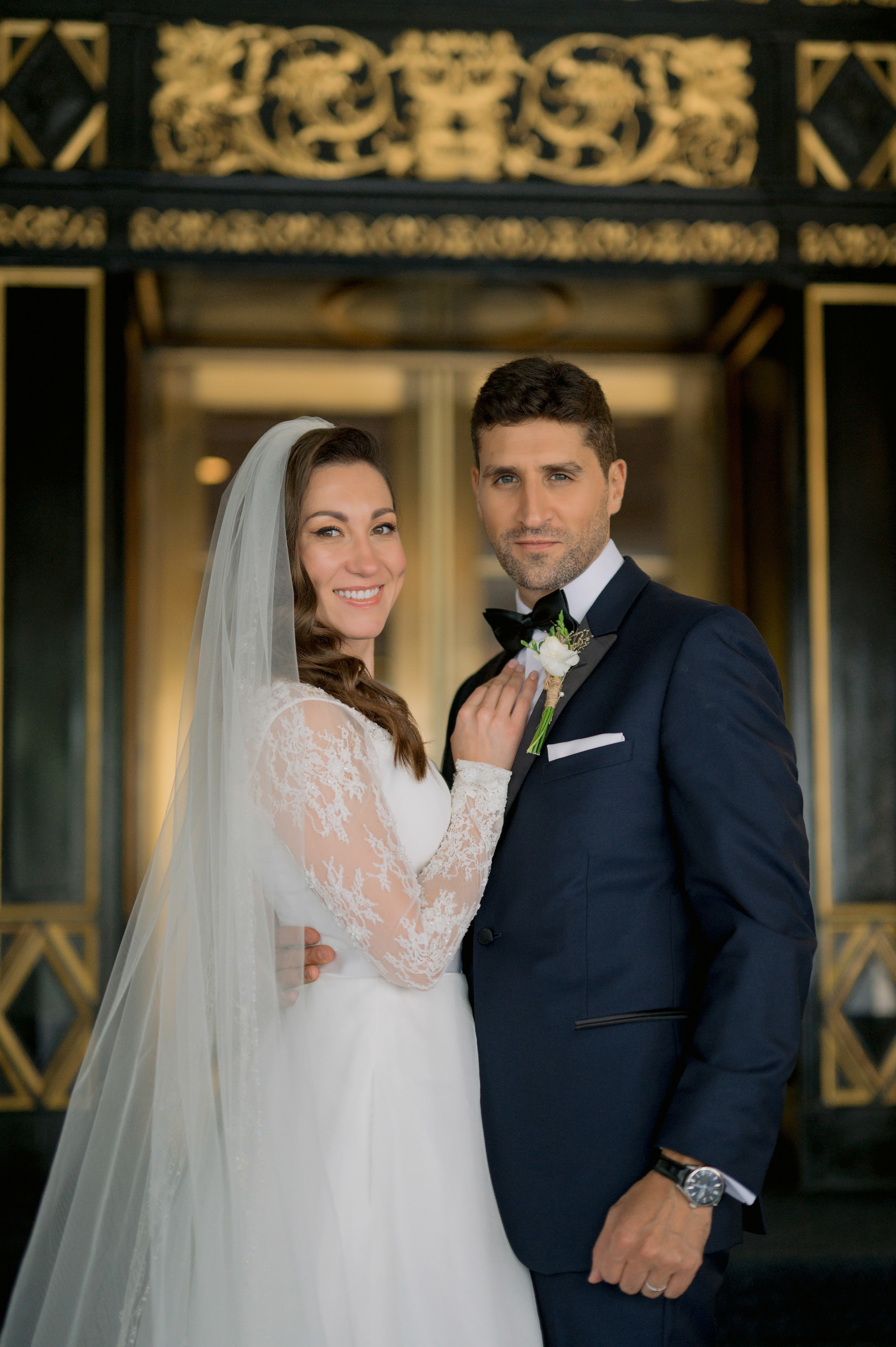 a bride and groom pose for a photo