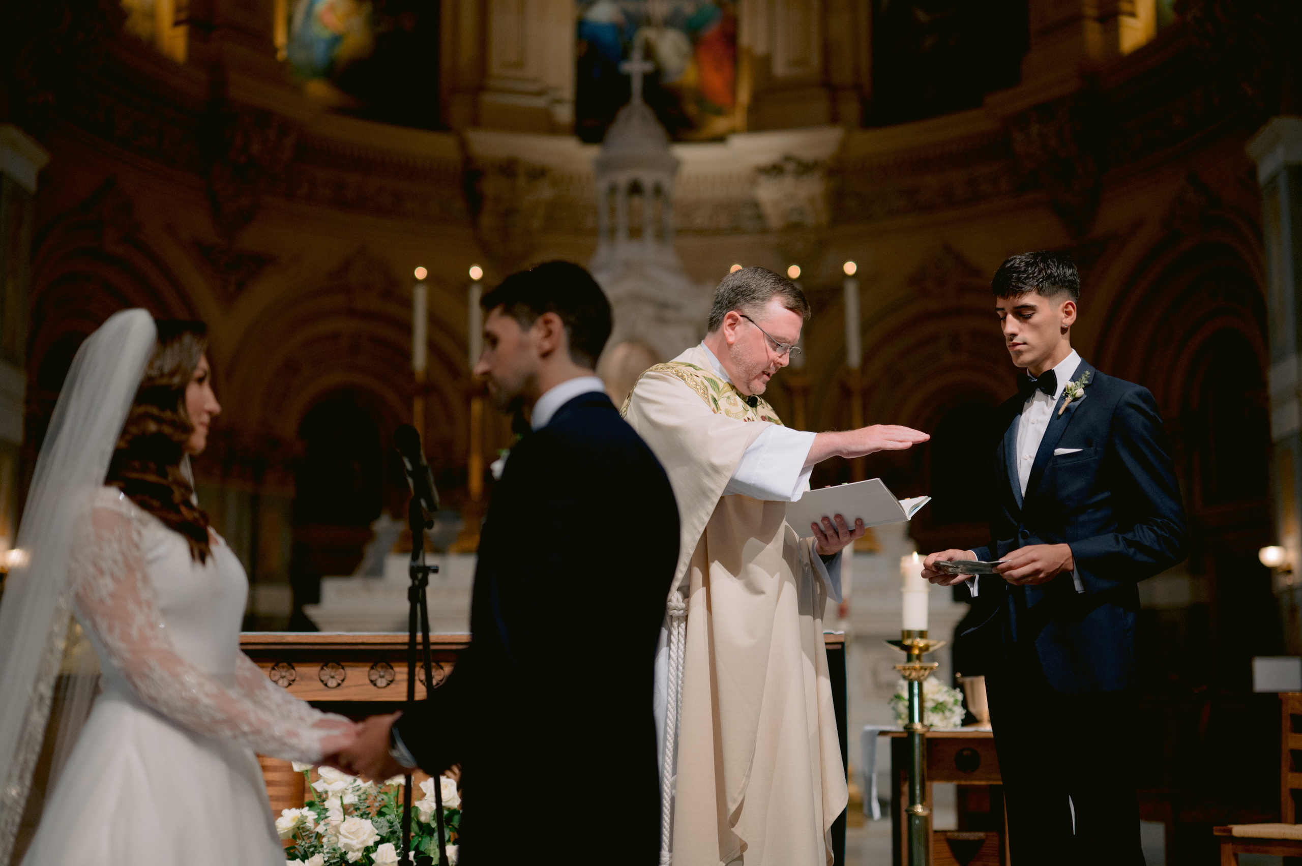 a man in a suit and tie is giving a woman a wedding ring