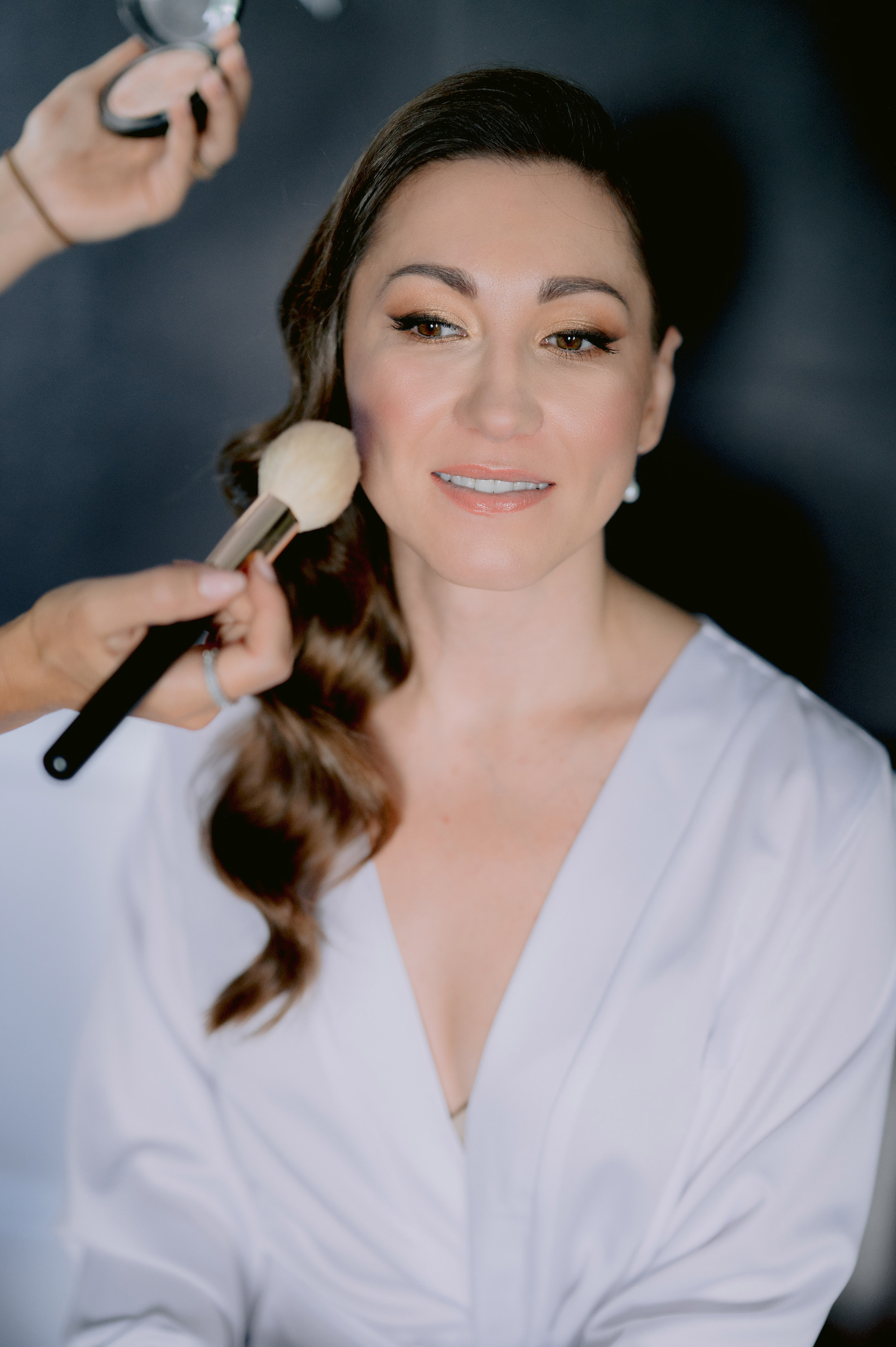 a woman is getting her hair done