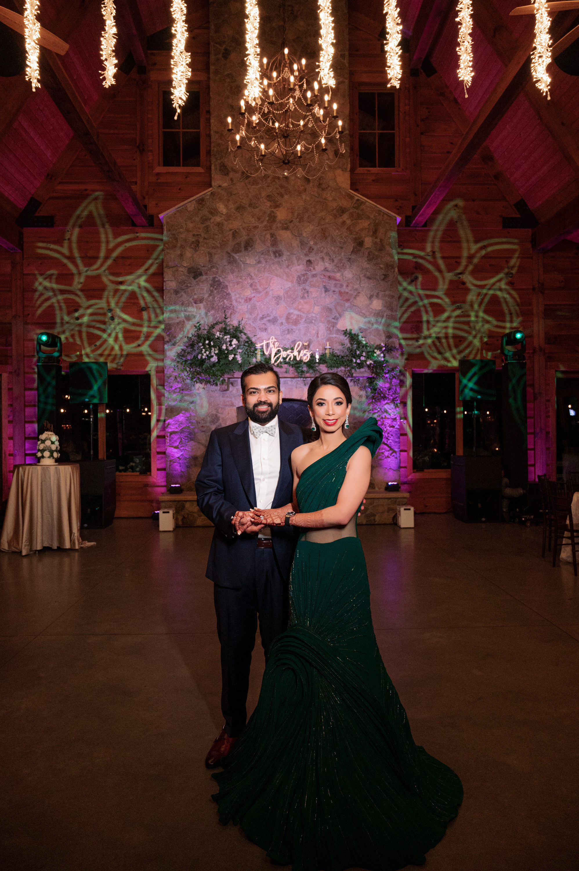 a couple posing for a picture in a ballroom