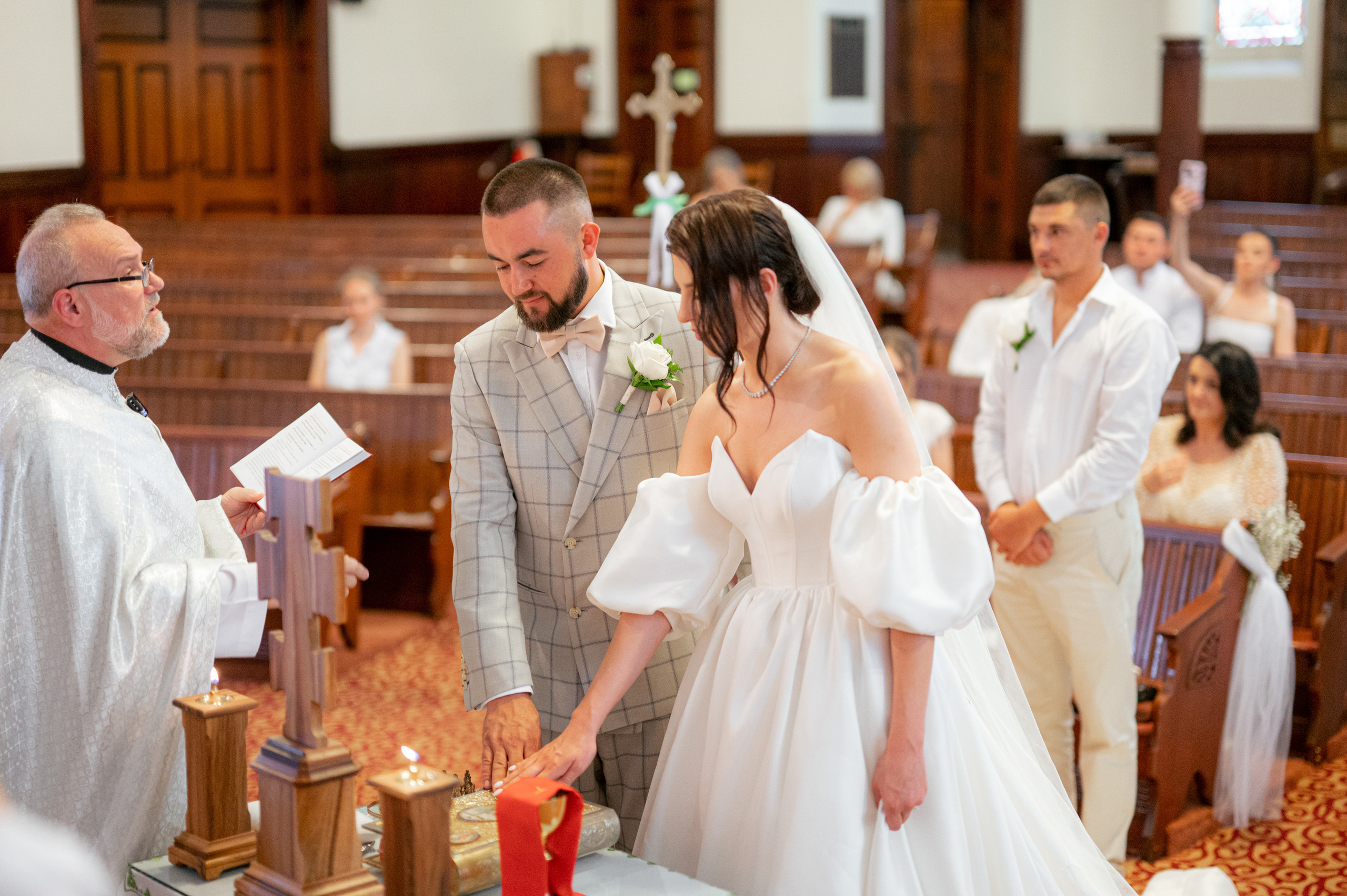 a man and woman are standing in a church