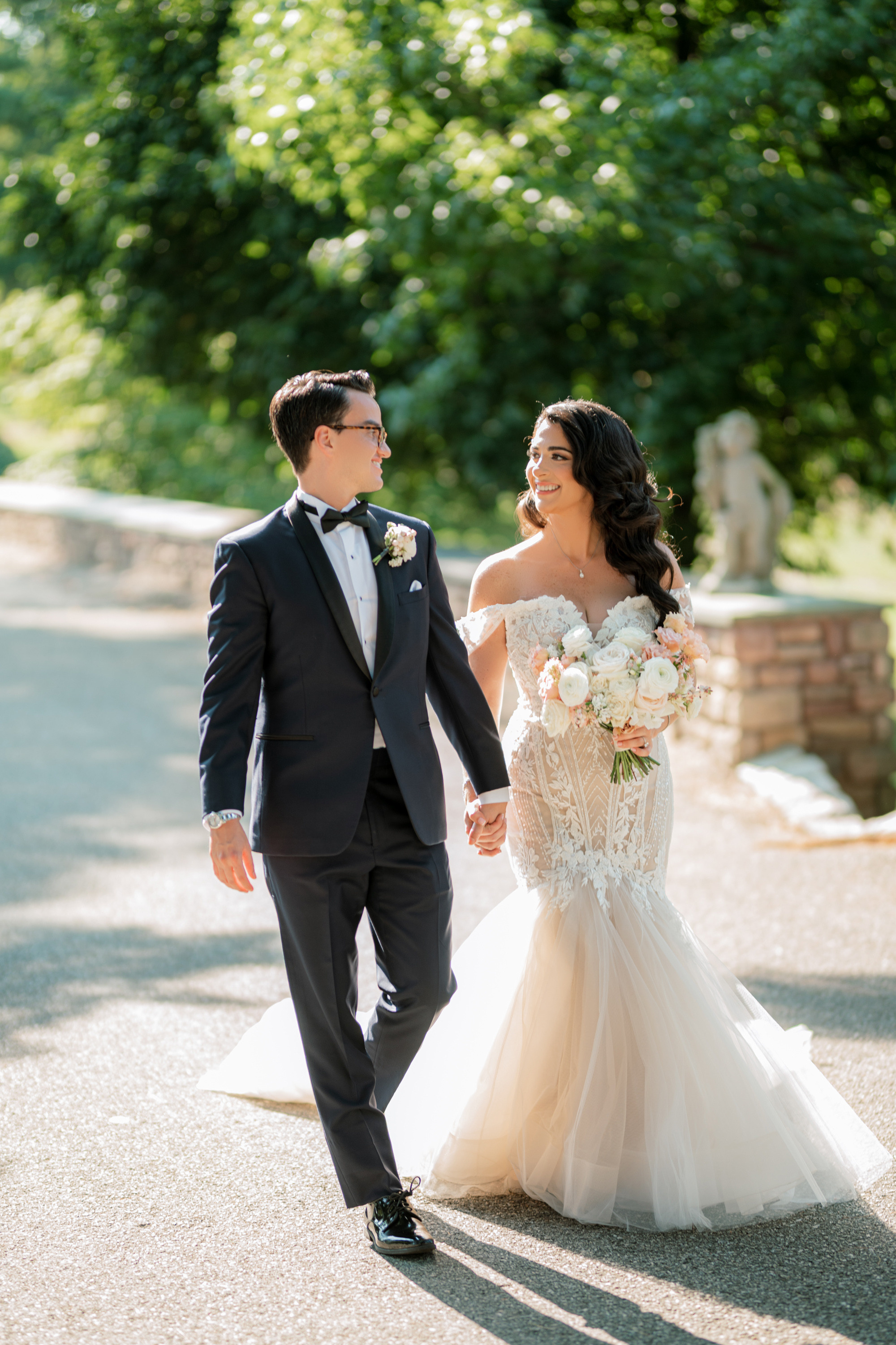 a bride and groom walking down the road