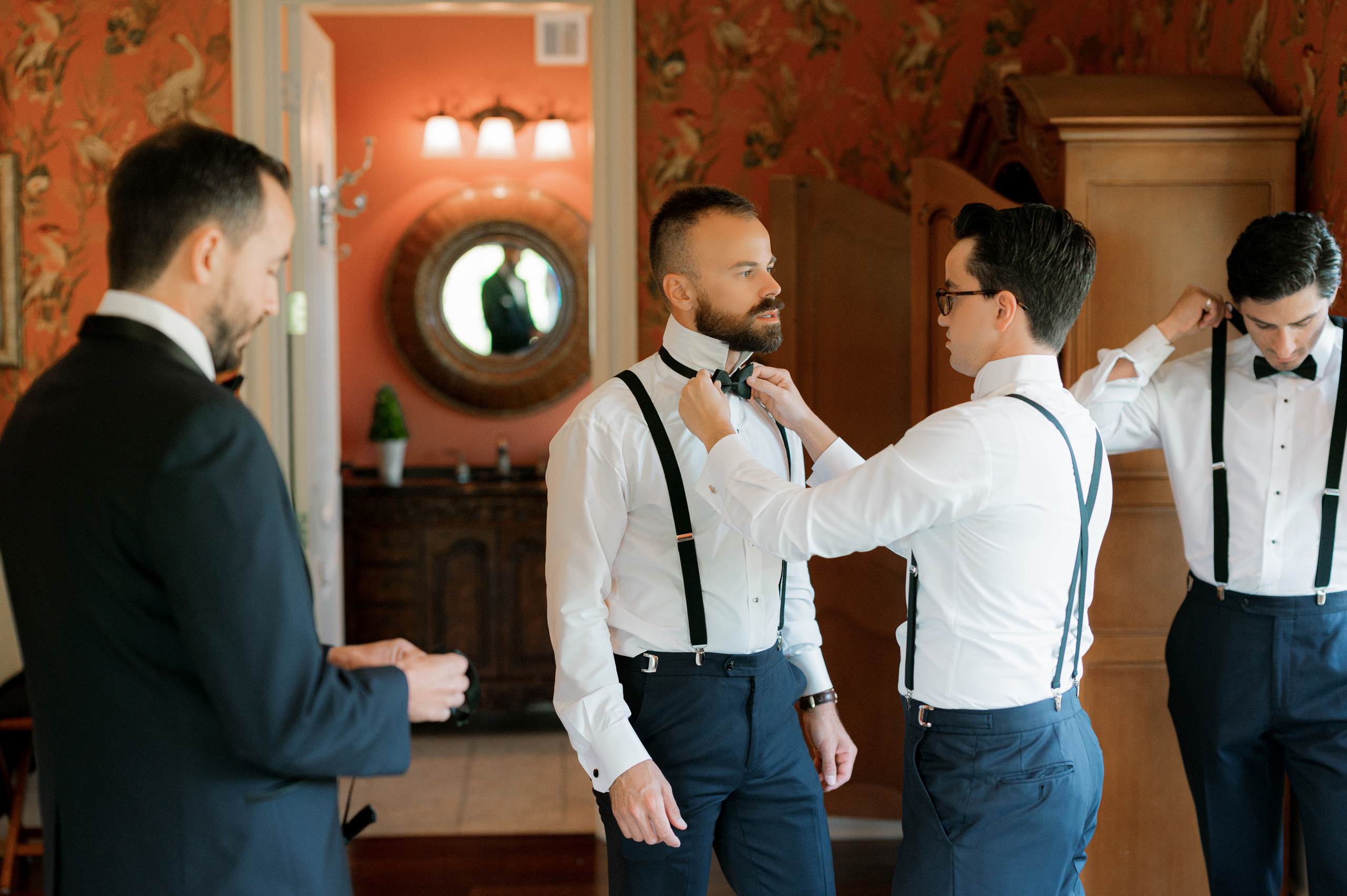 a man in a suit fixing his tie
