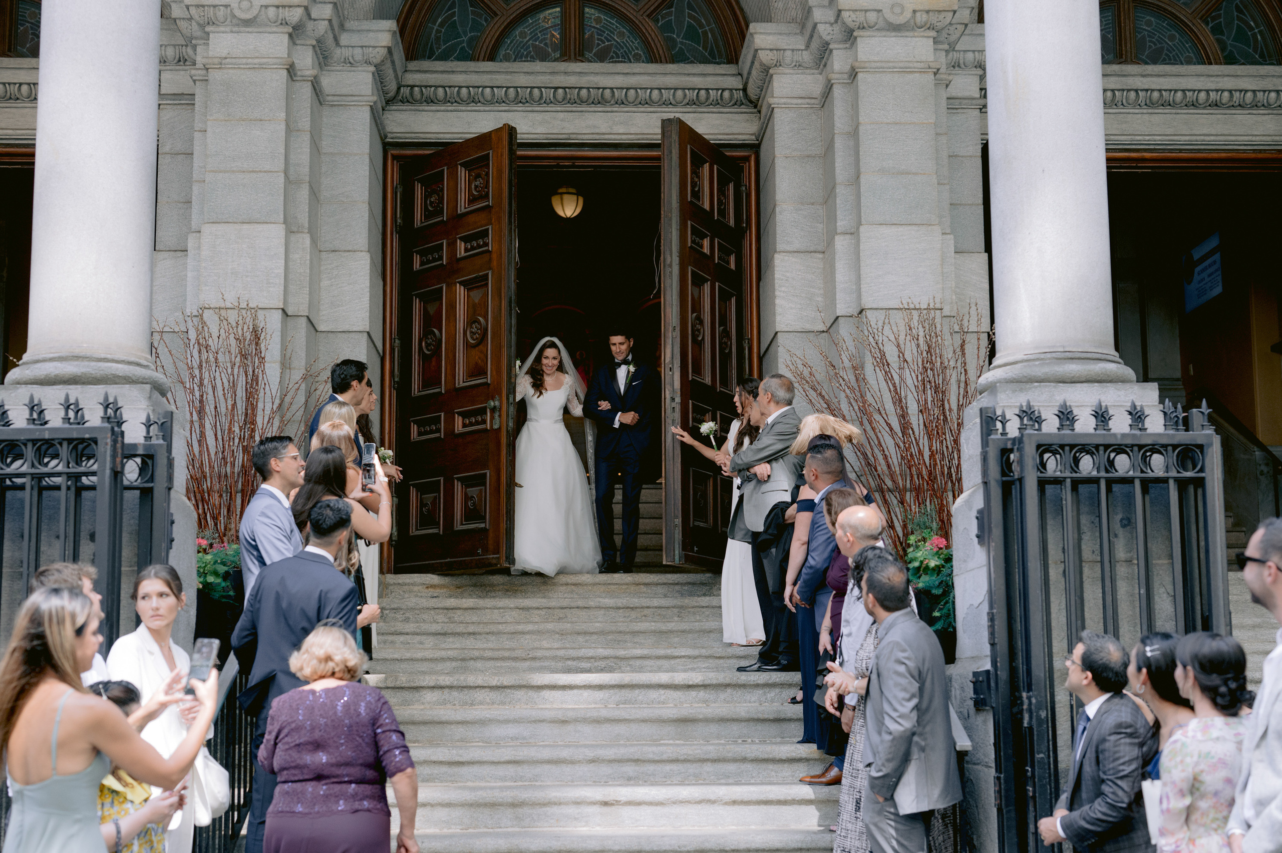 a couple getting married at the entrance of a church