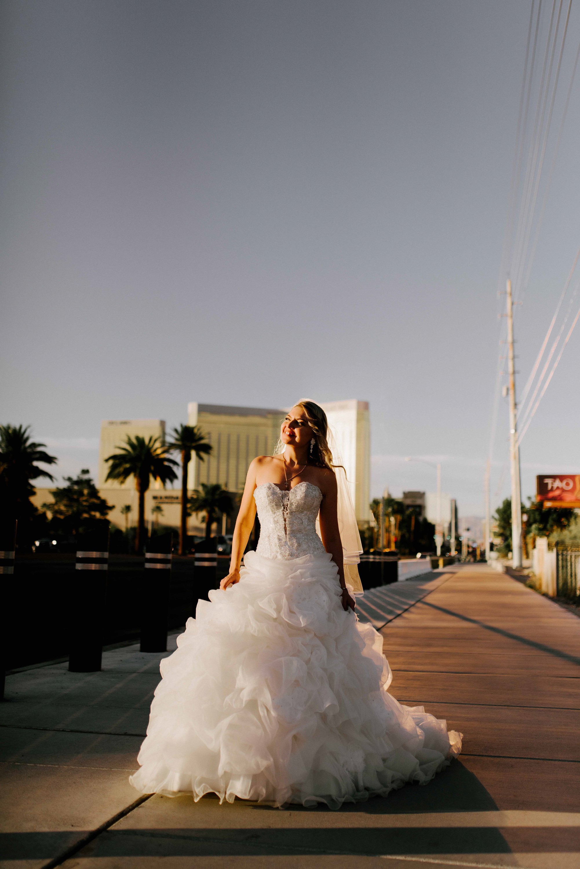 a bride is walking down the street in a wedding dress