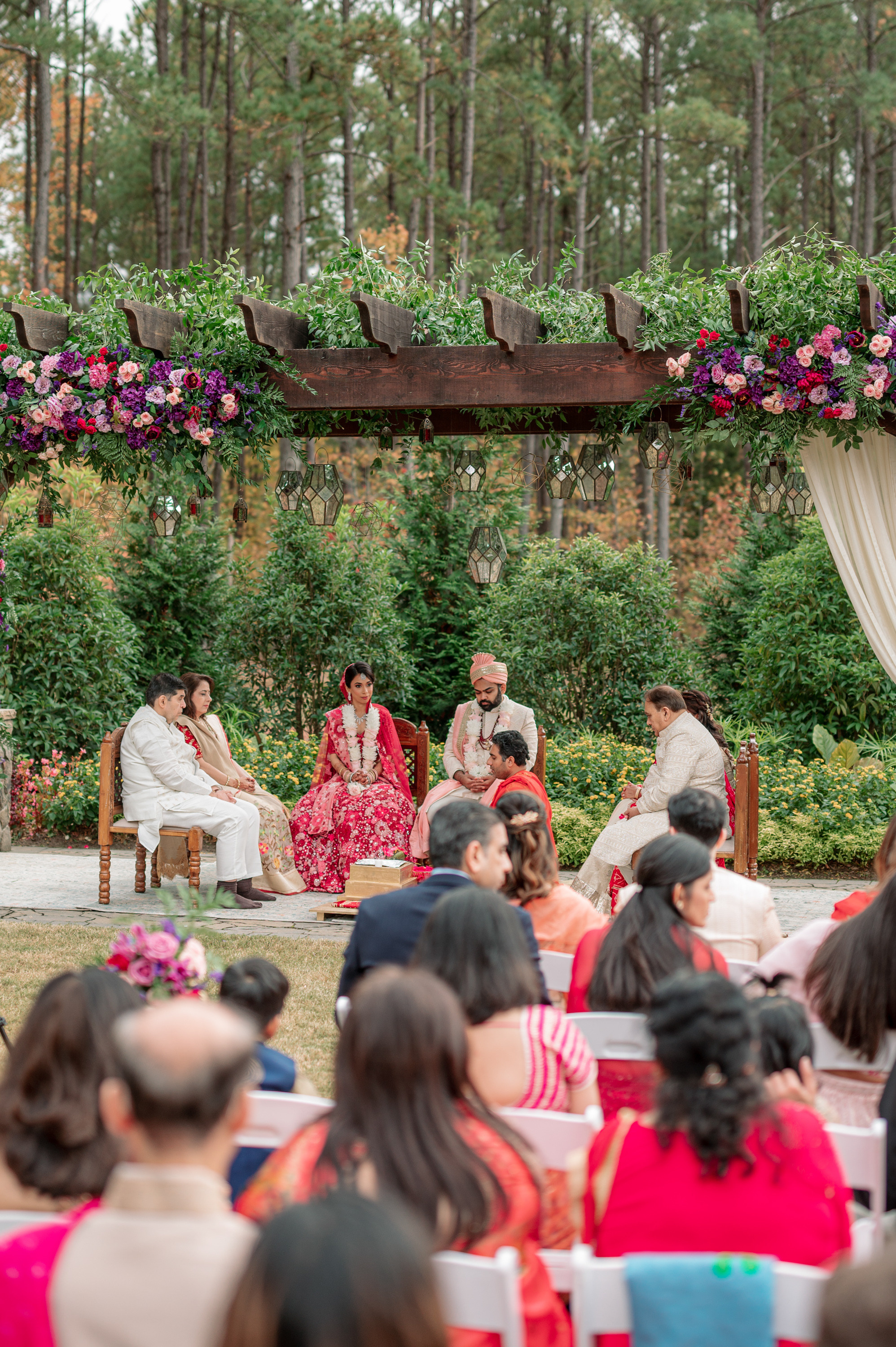 a couple sitting on a bench during a wedding ceremony