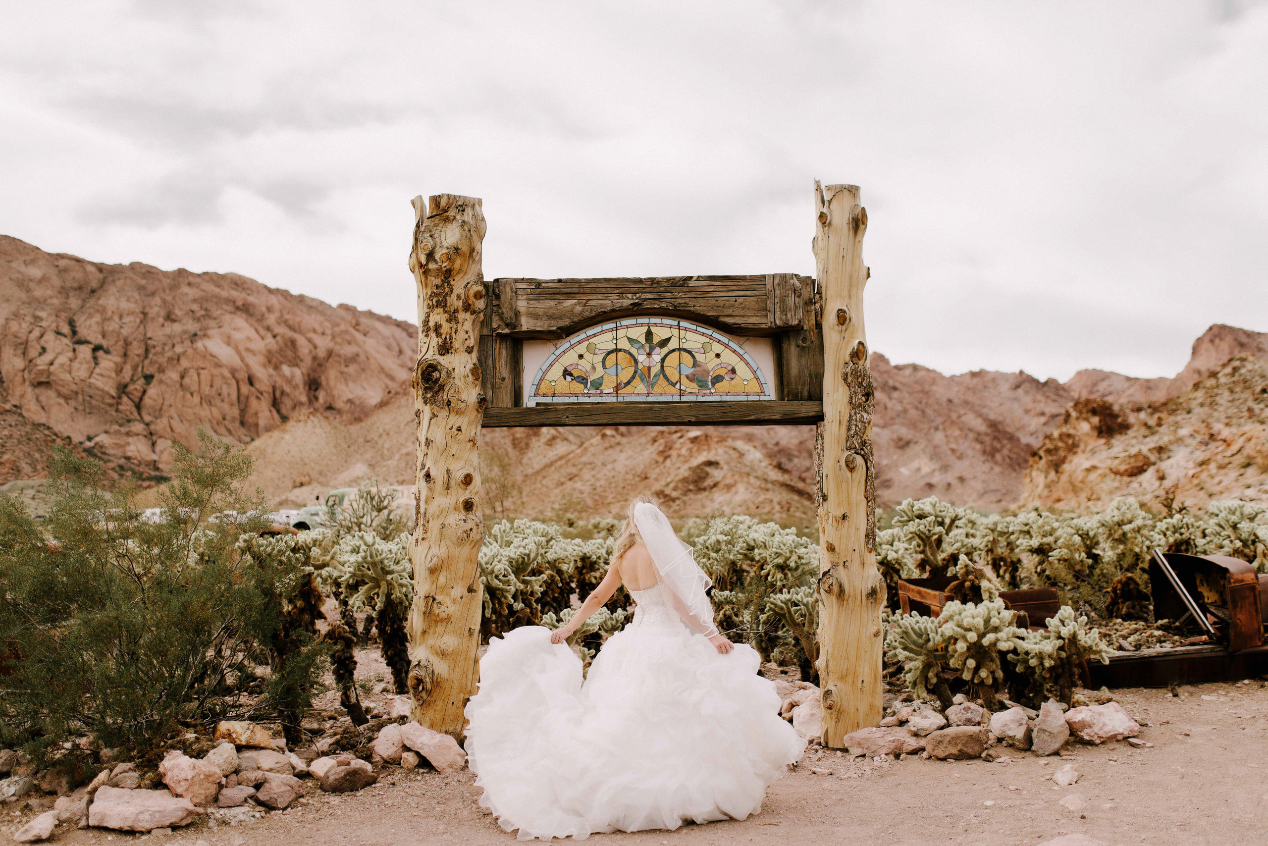a bride is sitting in front of a sign