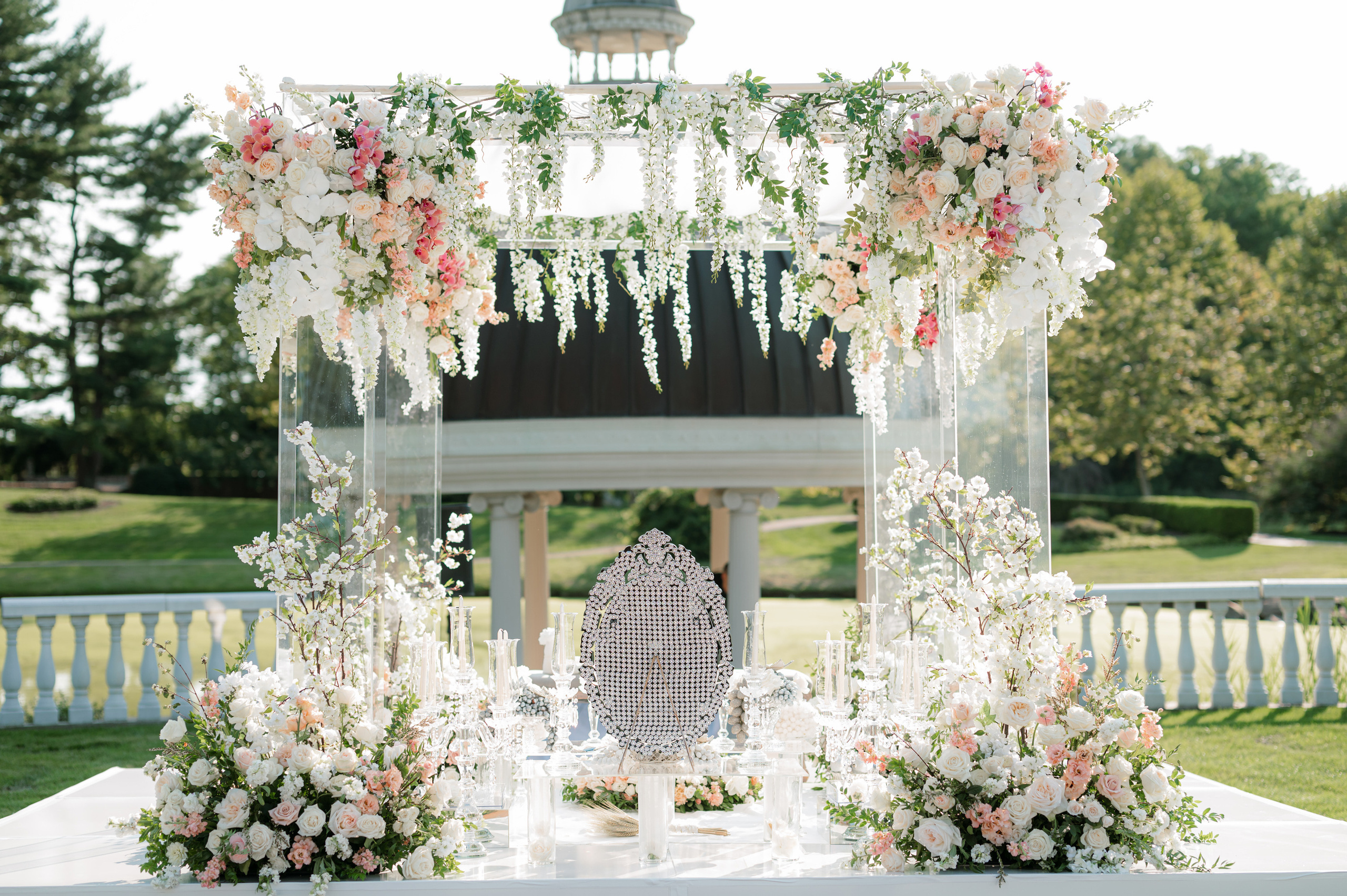 a white table with flowers and a white chair