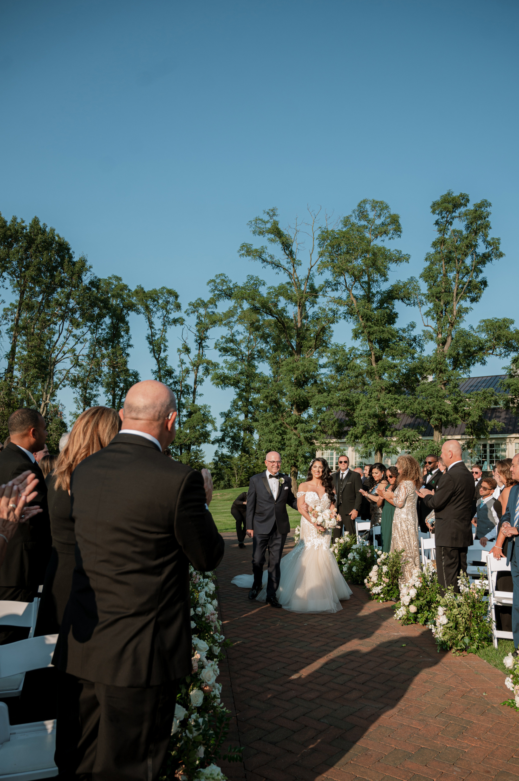 a bride and groom walking down the aisle