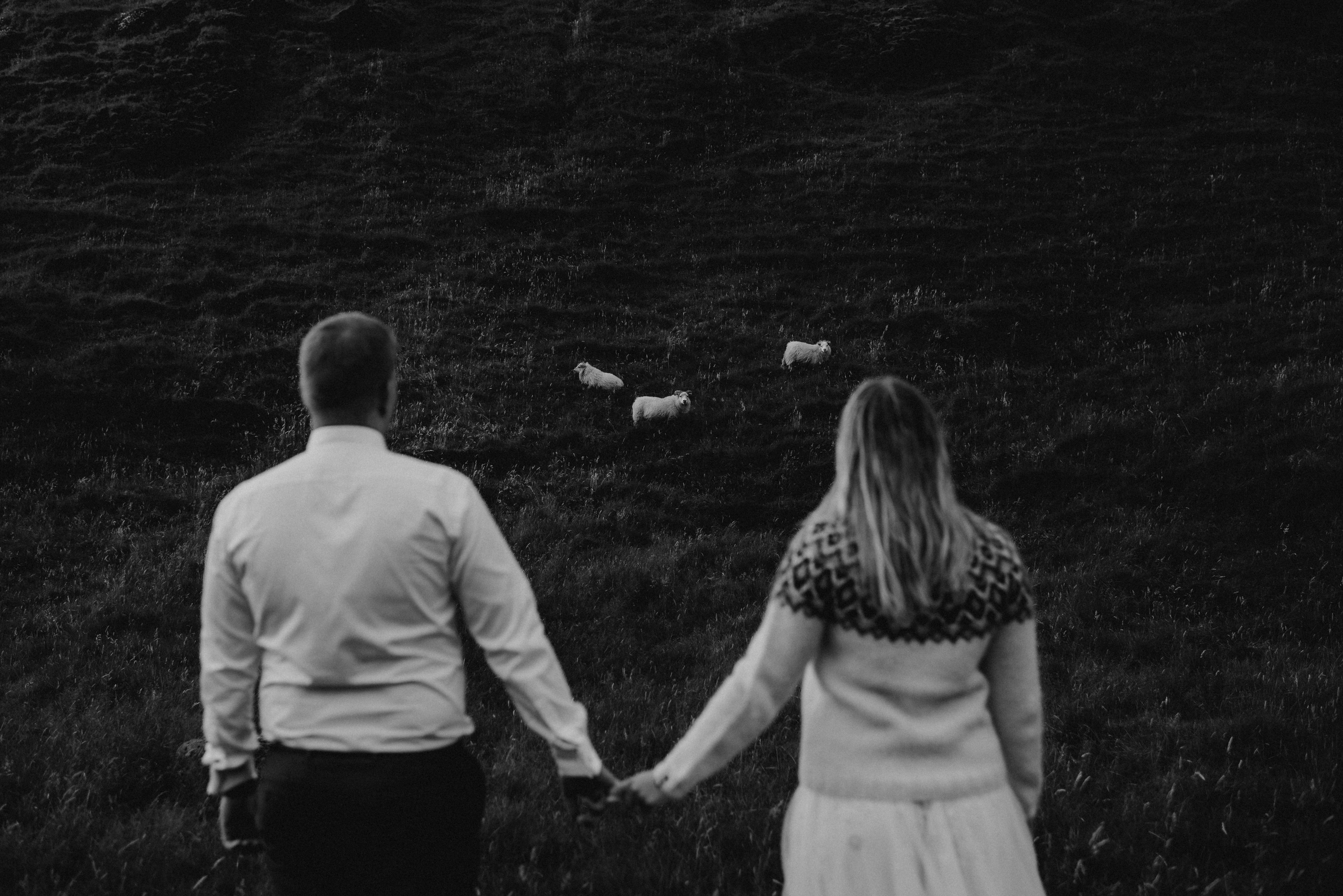 Eloping couple exploring the lush green canyon near Kvernufoss, surrounded by untouched Icelandic nature.