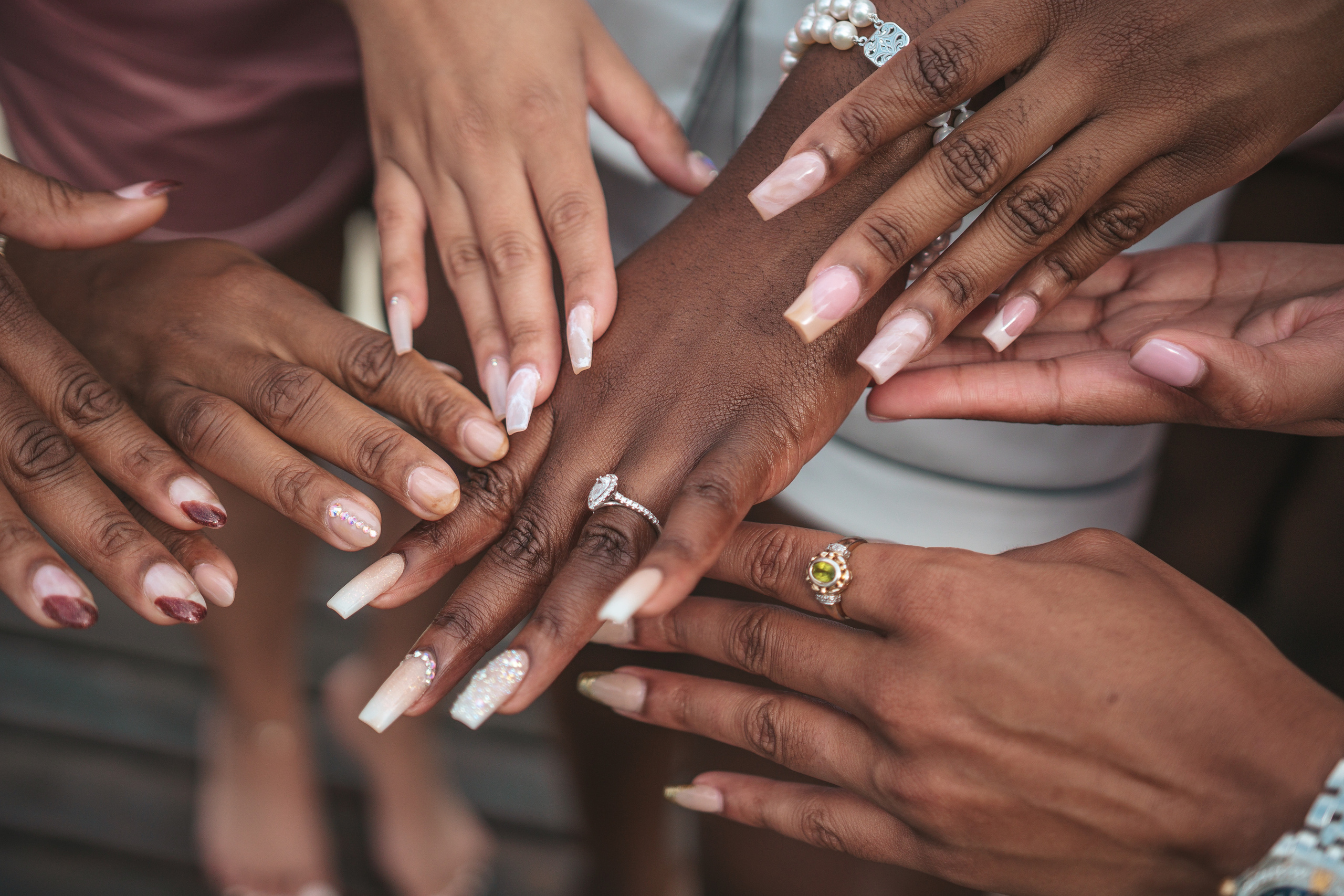 Bride showing engagement ring to bridesmaids in Cancun hotel