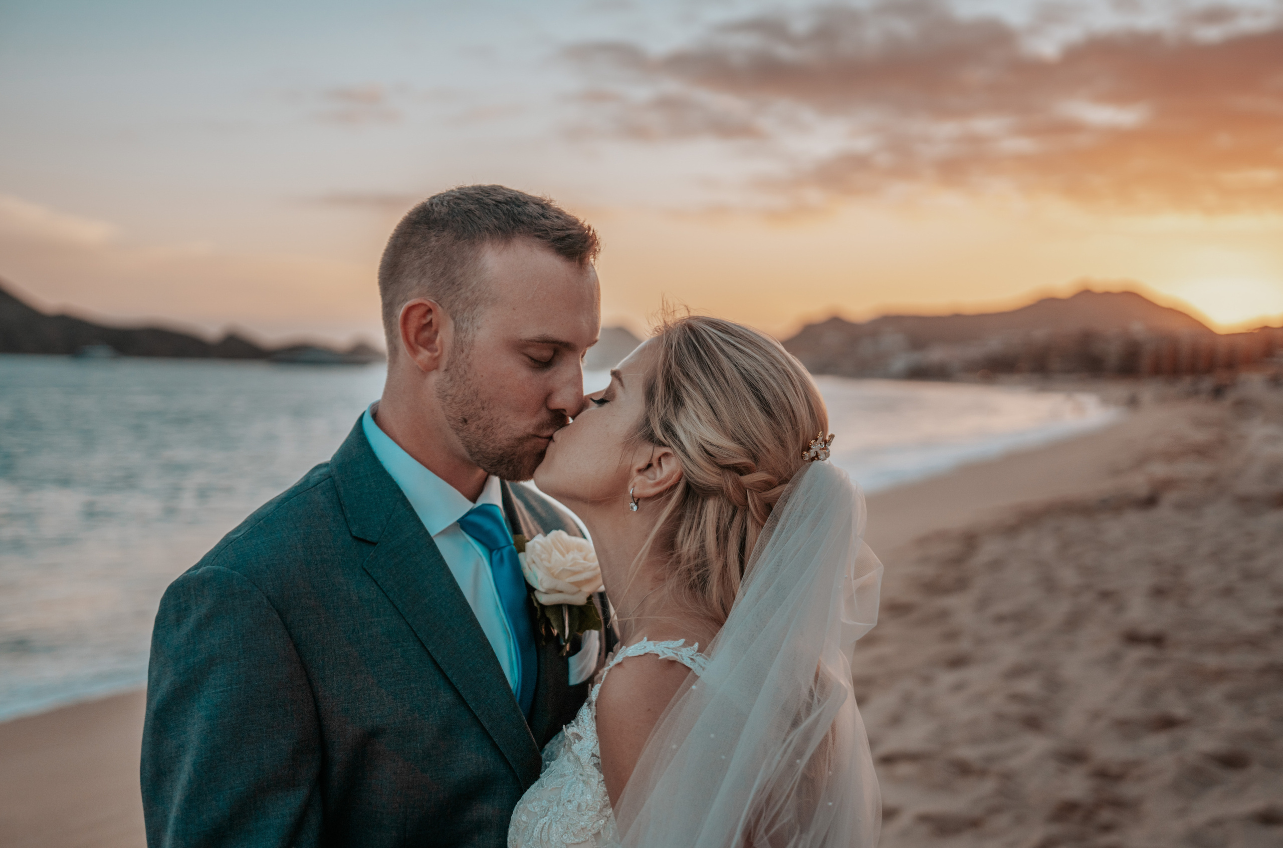 Romantic beach wedding photo at sunset in Cabo San Lucas