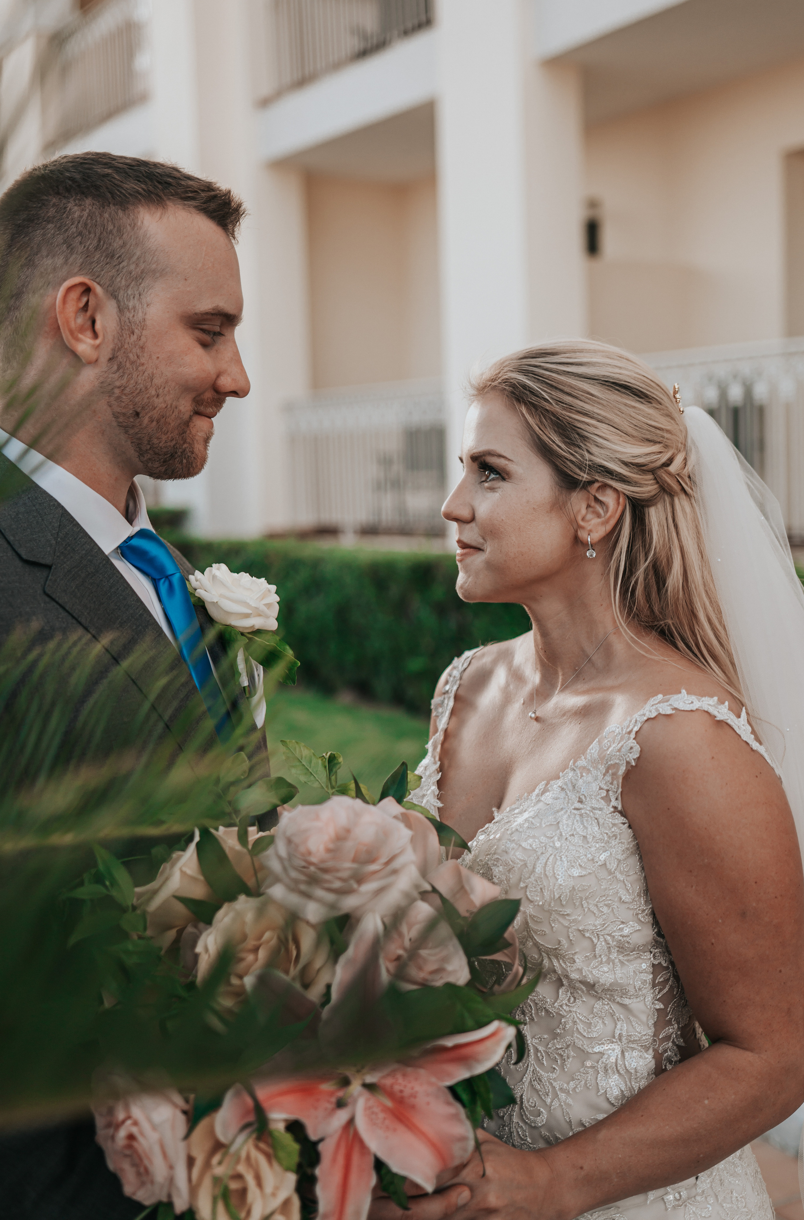 Bride and groom exchanging loving look at beachfront resort wedding in Cabo San Lucas