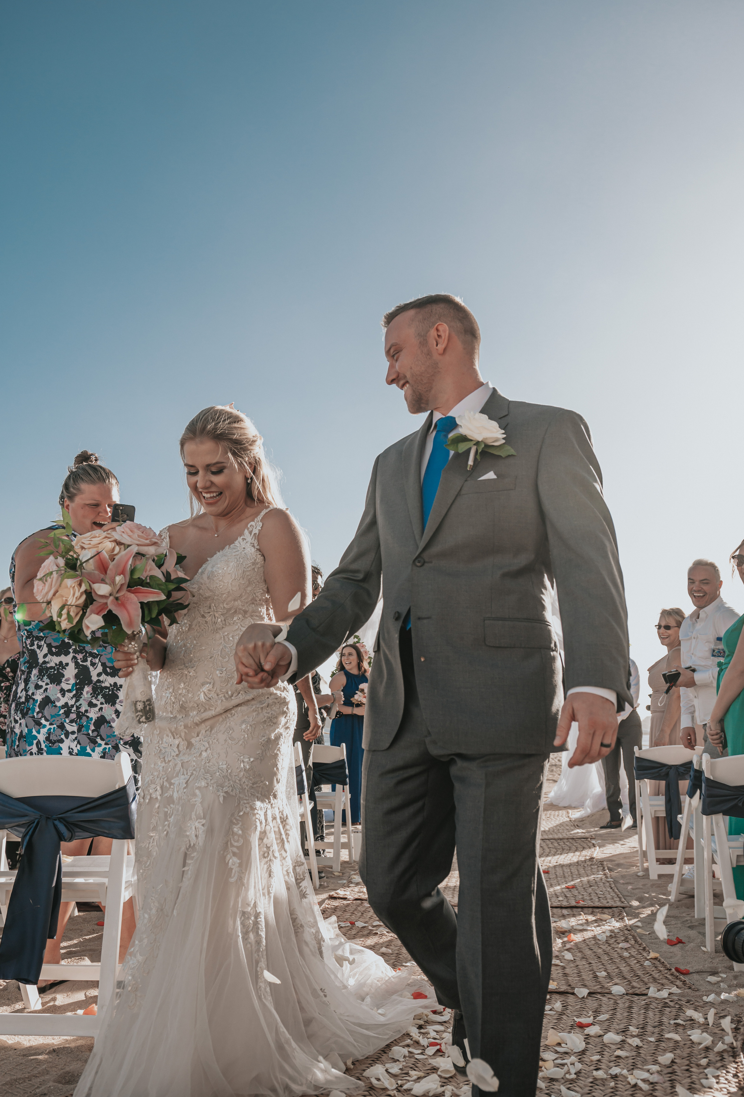 Destination couple celebrating love at Cabo beach altar