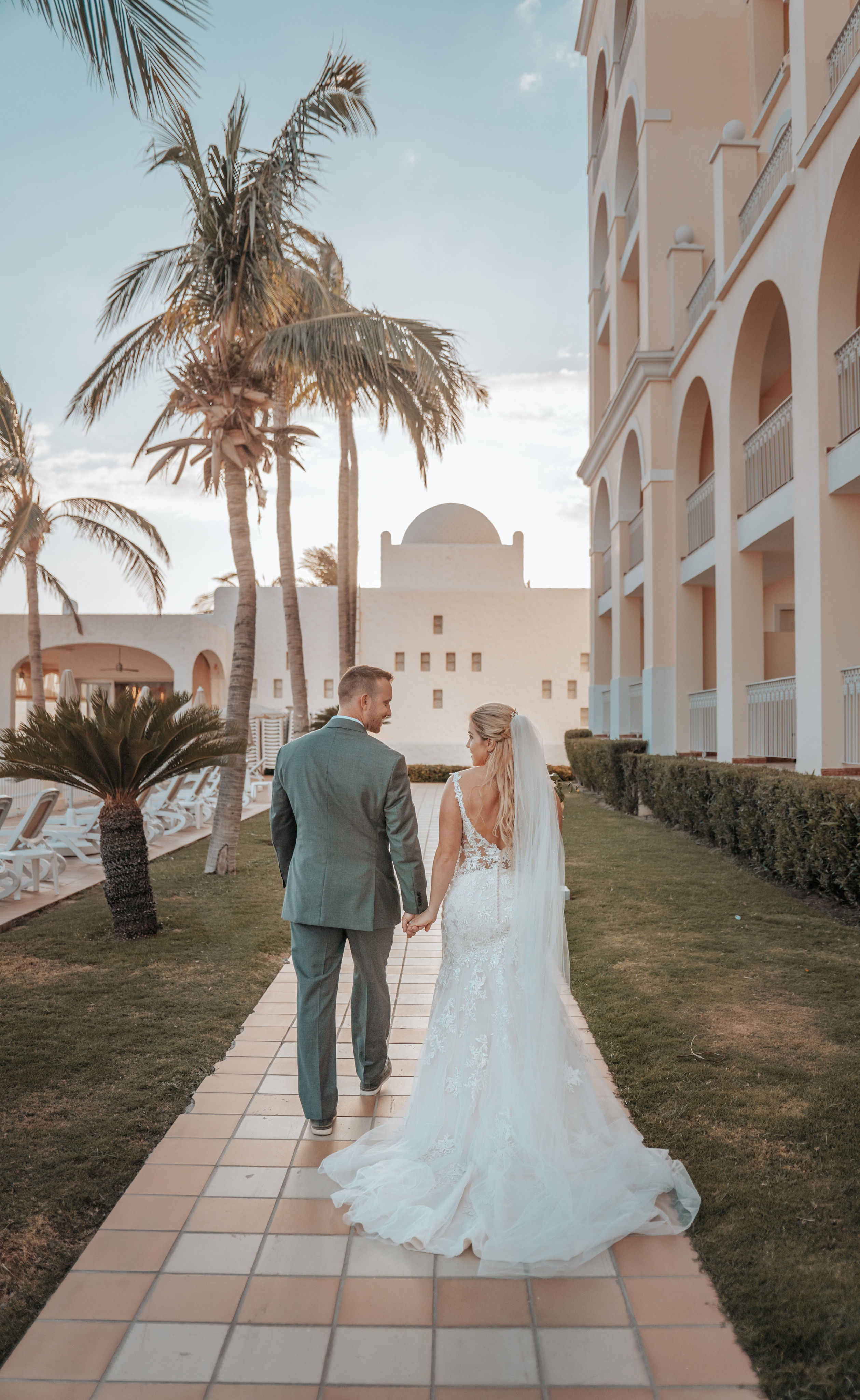 Romantic wedding moment surrounded by palm greenery at Cabo venue