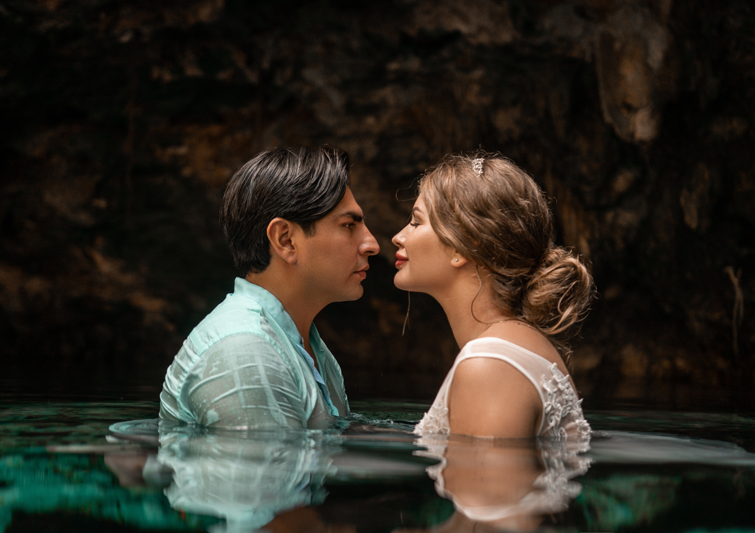 Emotional wedding day photo in ancient cave cenote
