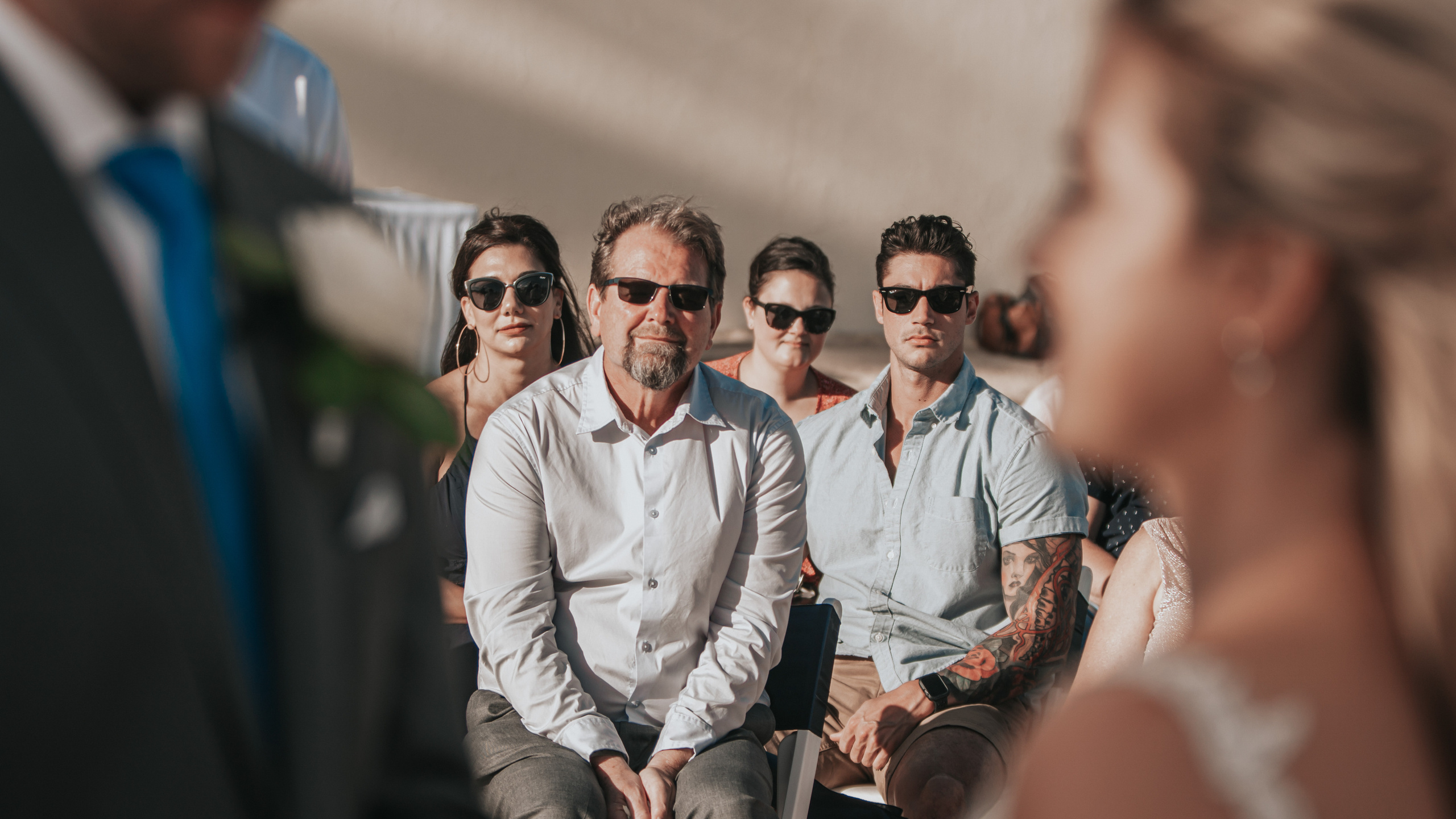 Oceanfront group photo during Mexican beach wedding celebration