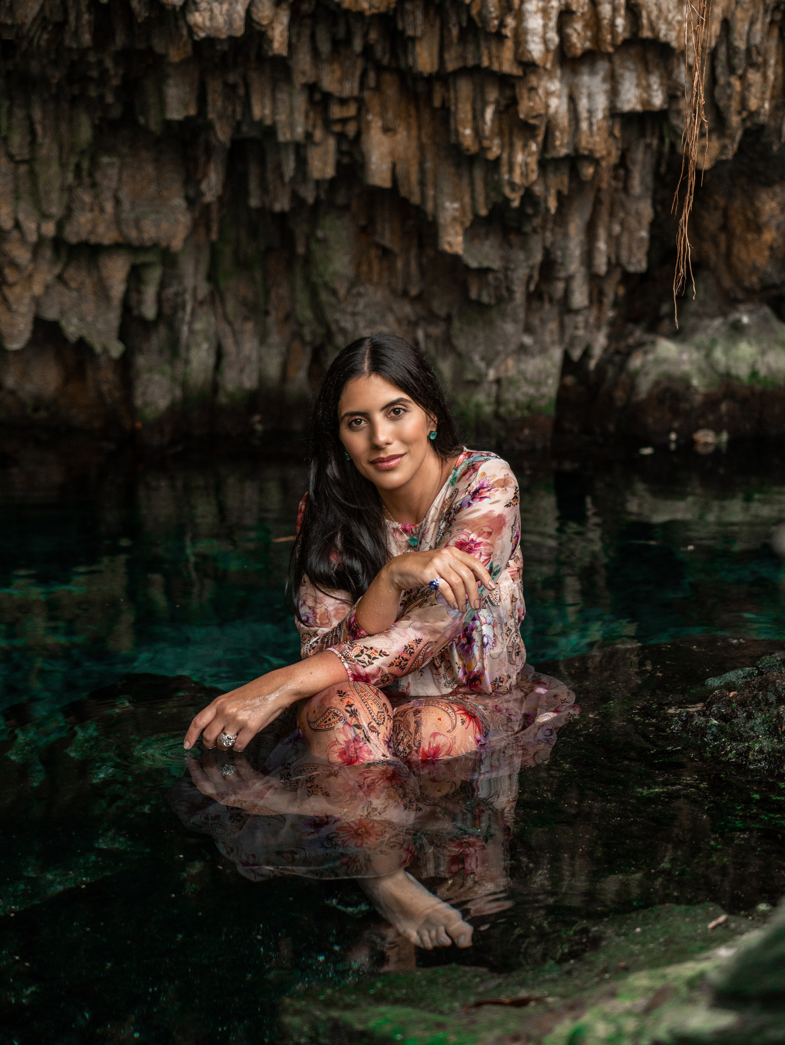 Luxury portrait of a woman swimming in a cenote near Tulum