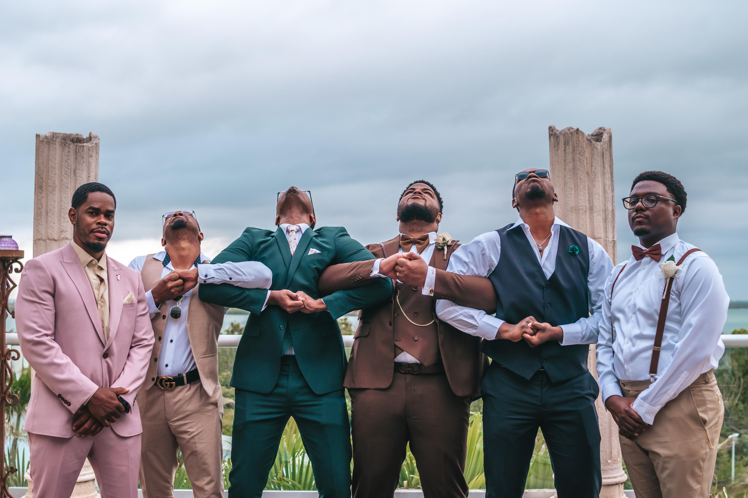 Destination wedding group portrait outside colonial-style venue in Mexico
