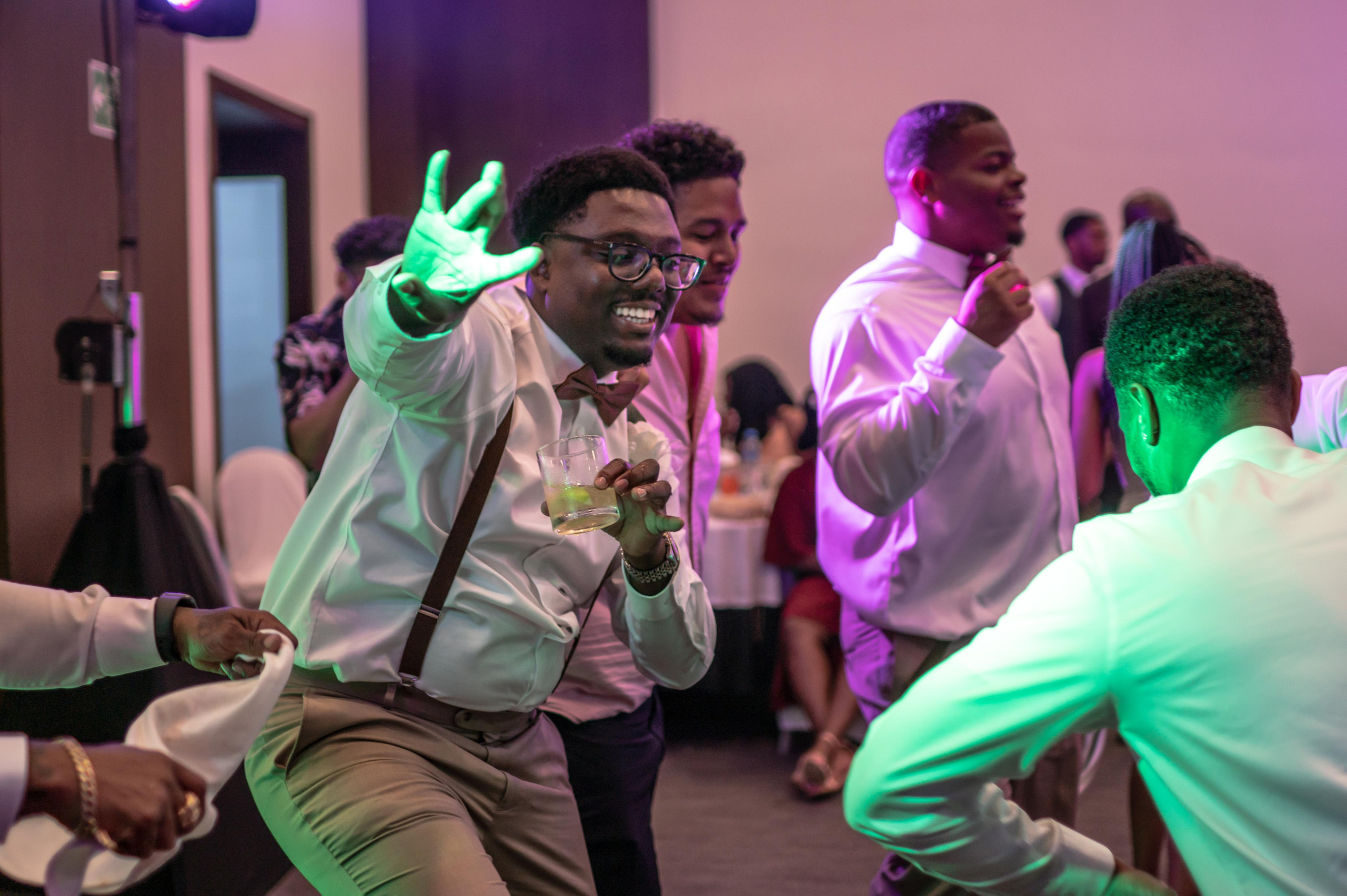 Guests dancing under blue lights at luxury wedding in Cancun