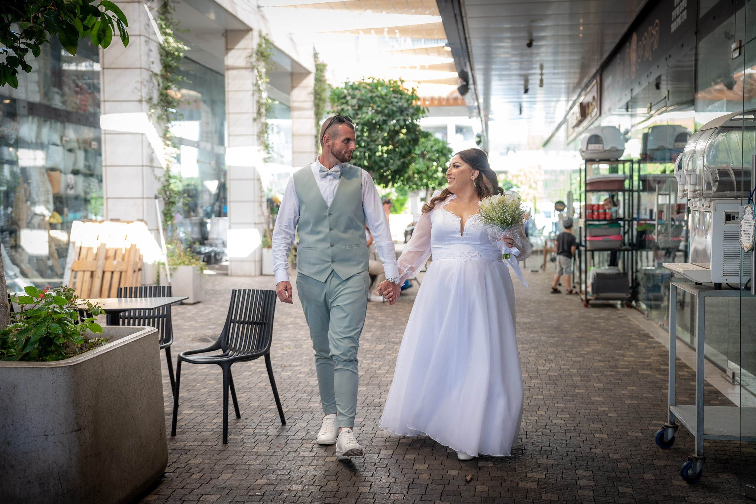 Ella and Matan walk together holding hands