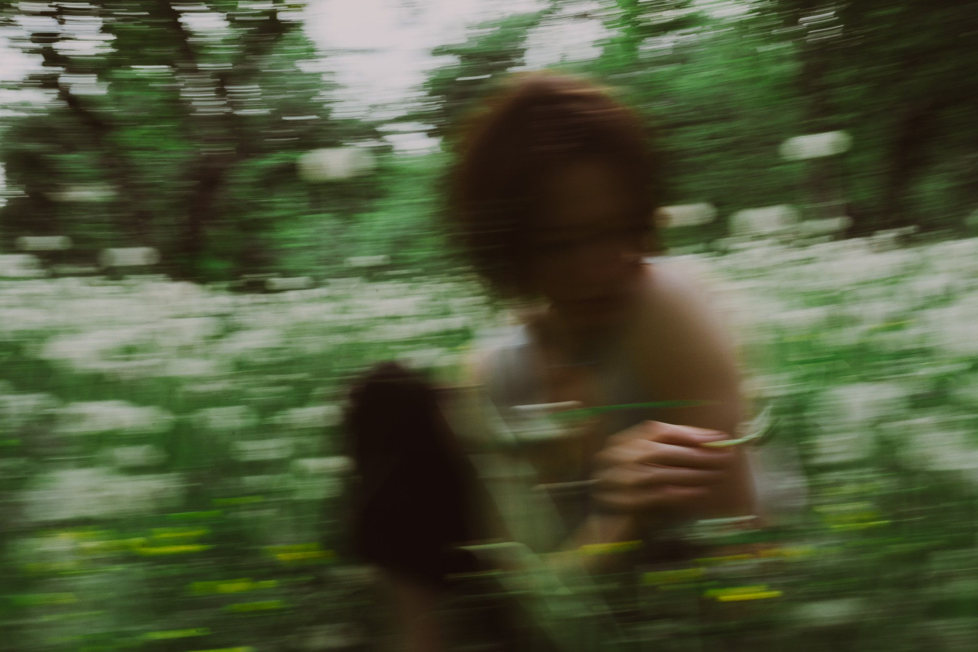 Soft focus portrait photography of a girl surrounded by greenery 